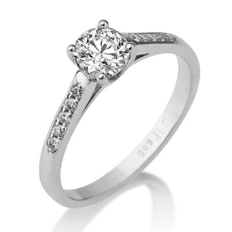 A beautiful handmade solitaire with accents diamond engagement ring made of White Gold set with a white natural diamond of 0.30 carat accented by 10 round diamonds. The center diamond of this classic gold ring is of Excellent cut, SI1 clarity and F