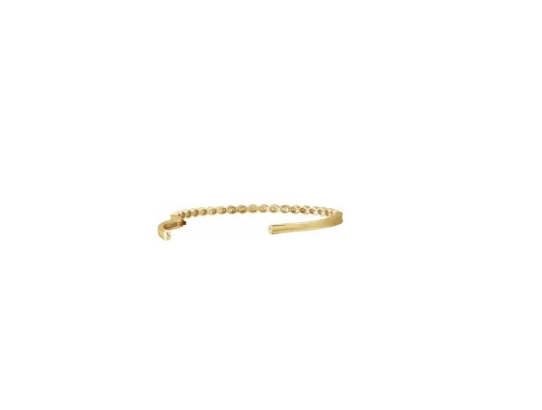 Modern classic. Stackable bangle is the perfect for work wear or lunch date with friends. Subtle piece made in 14kt yellow gold. The natural diamonds flawlessly accent the design giving it simple yet chic, classy look. Giving your persona a 