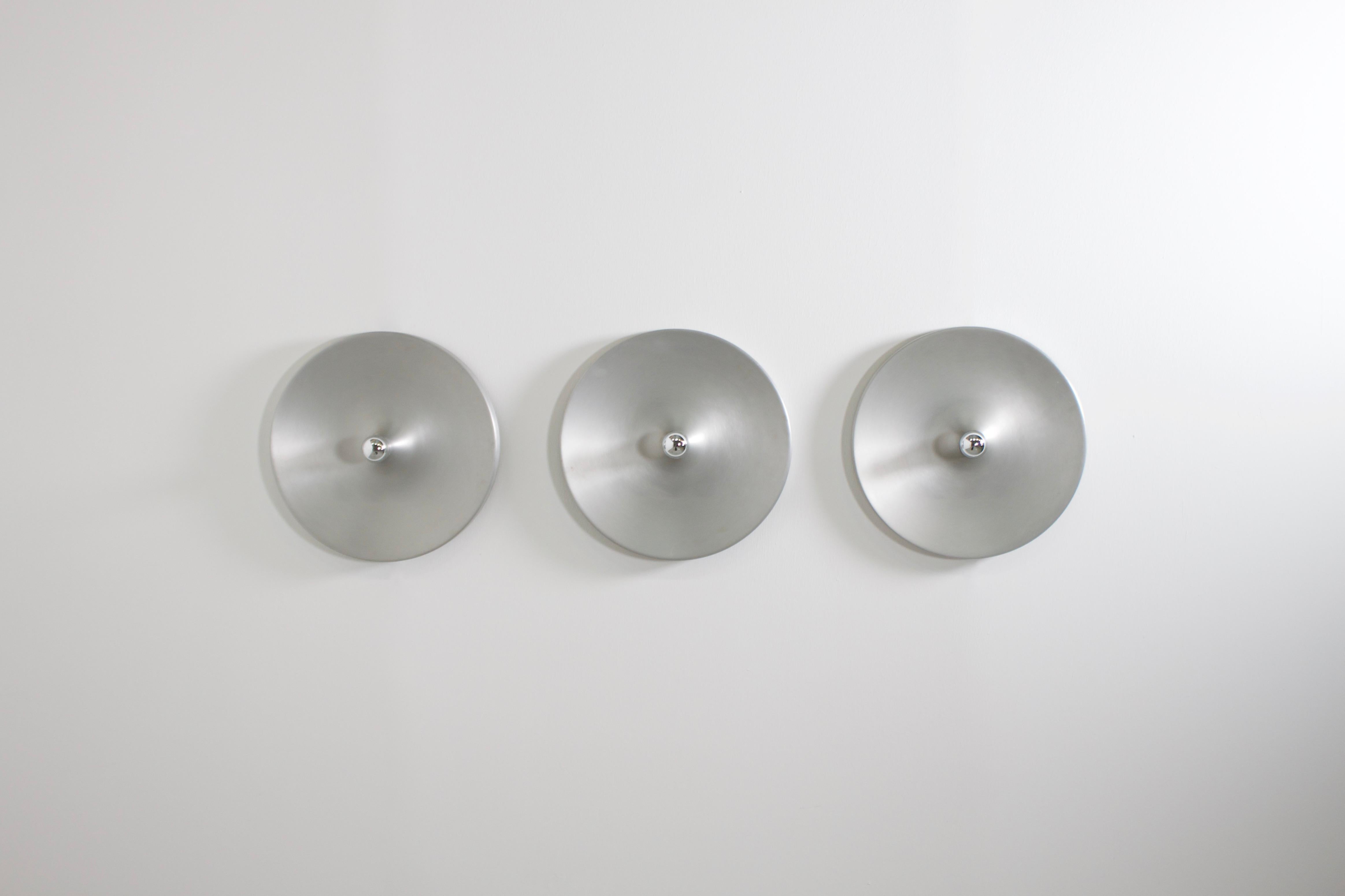 Aluminum sconces in very good condition.

6 lamps available

These lamps were used by Charlotte Perriand to decorate the apartments of Les Arcs Ski Resort in France 

They are made of aluminum and when used with a mirrored light bulb they generate a
