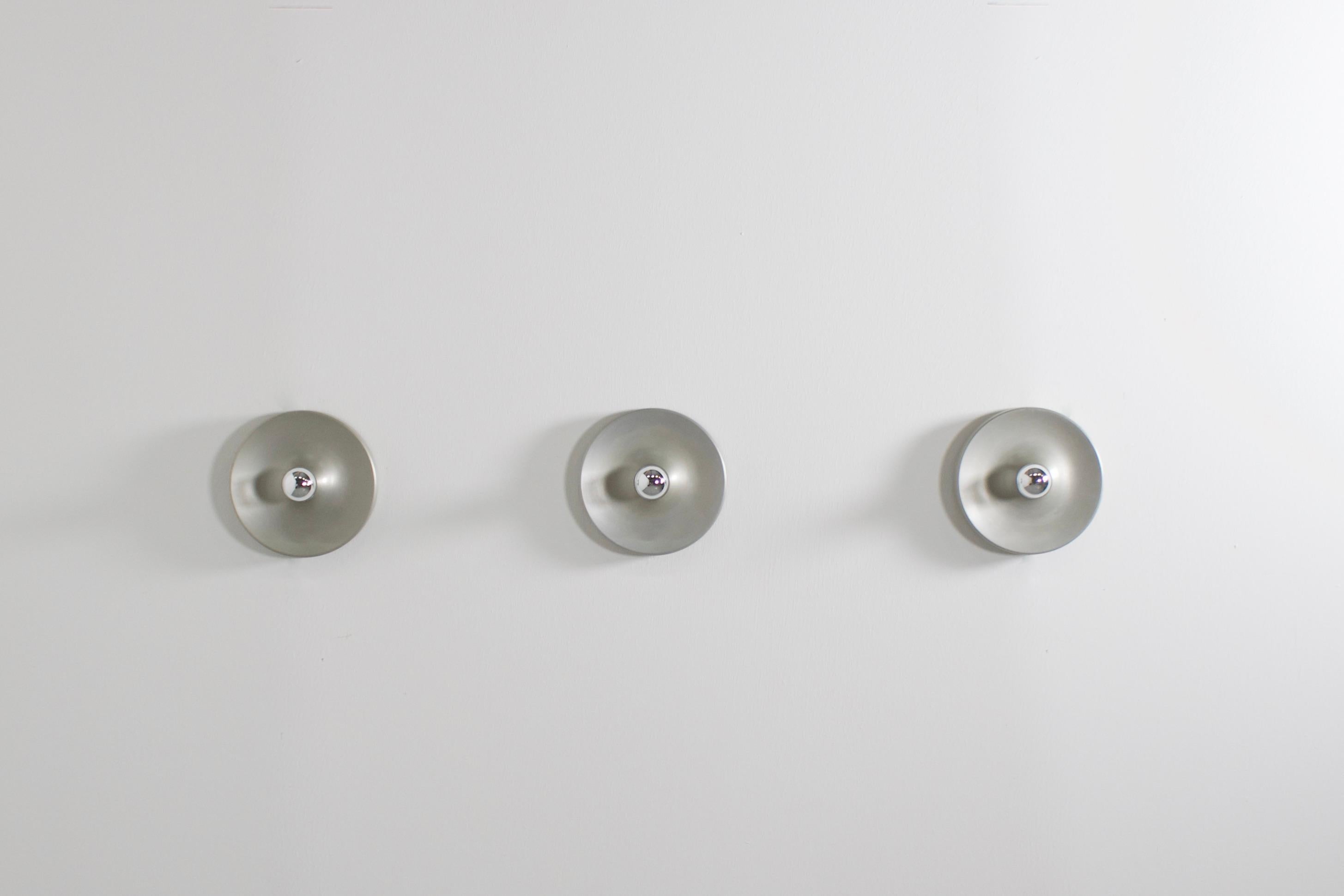 Aluminum sconces in very good condition.

8 lamps available

These lamps were used by Charlotte Perriand to decorate the apartments of Les Arcs Ski Resort in France 

They are made of aluminum and when used with a mirrored lightbulb they generate a