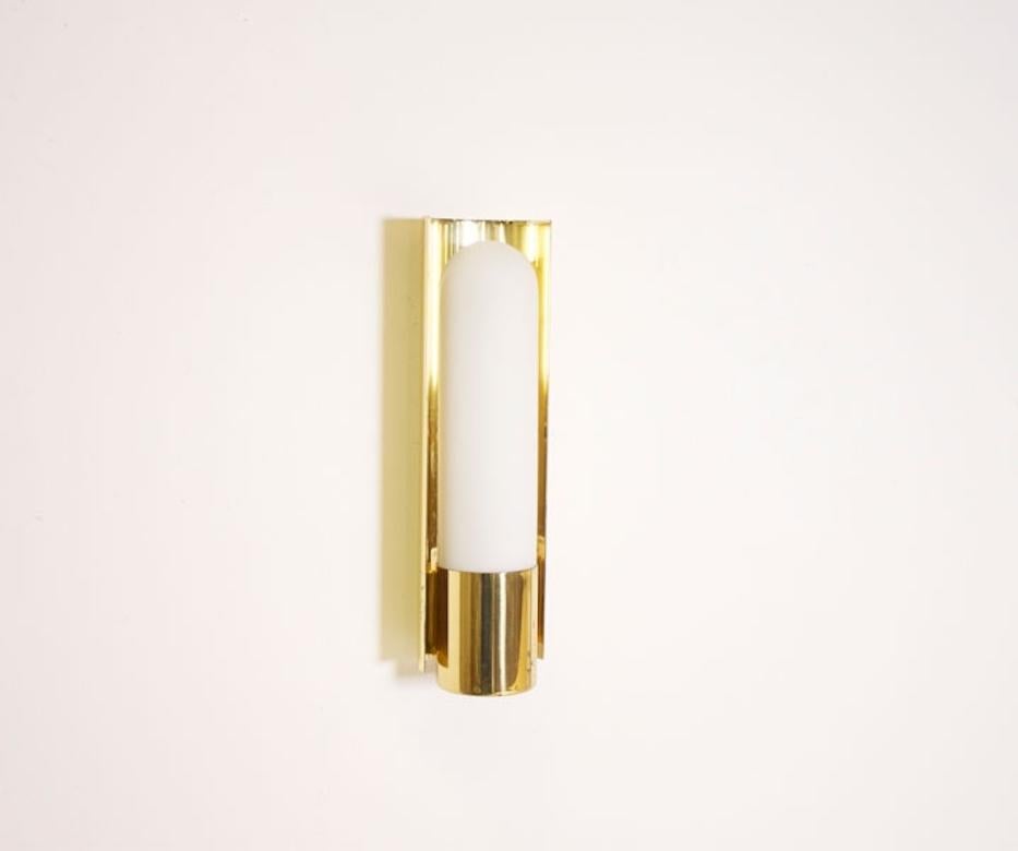 Set of ten brass and opaline Glashütte limburg wall lights.

Polished brass with an opaline glass cylindrical diffuser that creates a beautiful diffused light. 

Marked: Glashütte Limburg. 

Can be sold singly, as pair or as set of three,