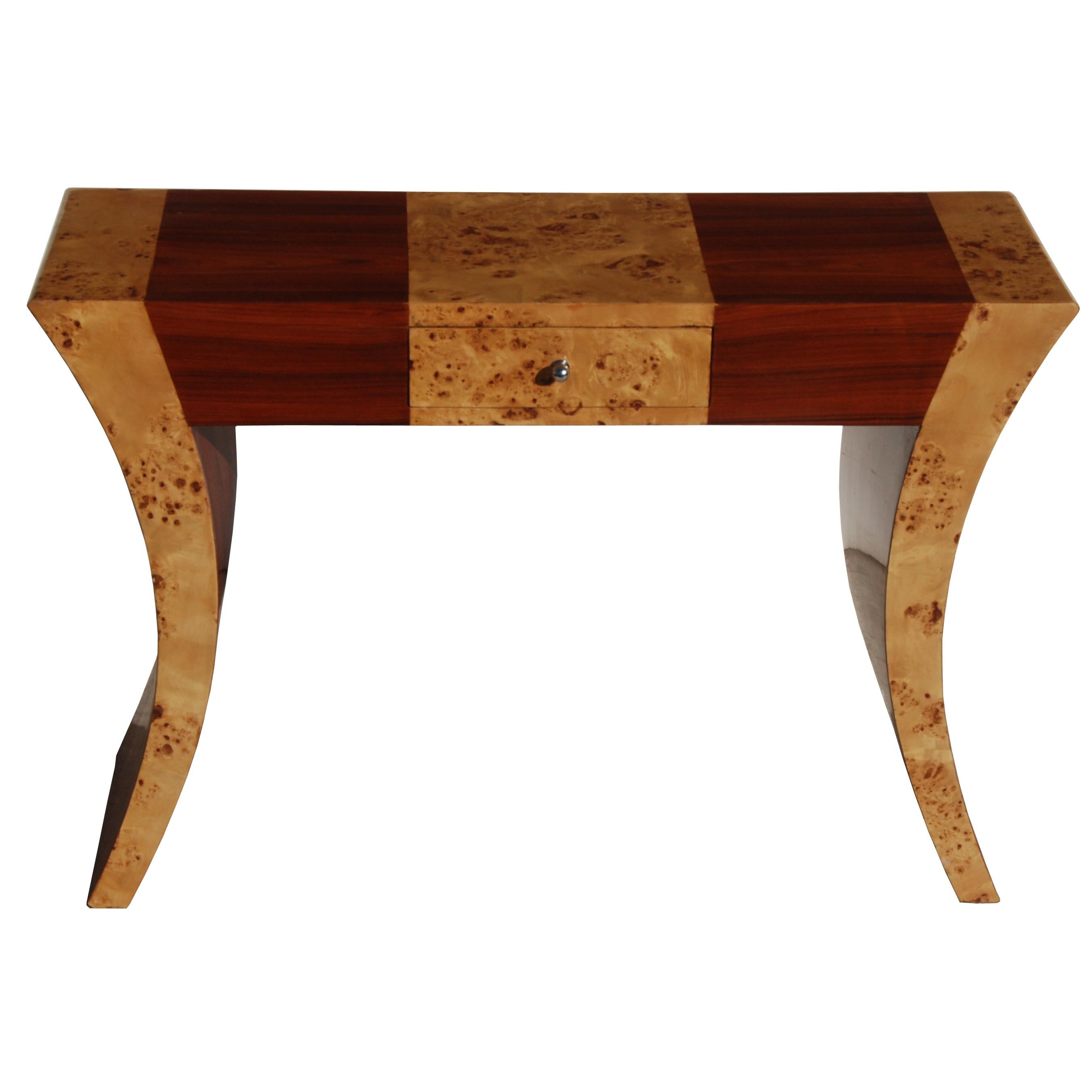 1 Art Deco style console table 

A rich mix of burl and other exotic woods are incorporated in this console. 
The back is finished for use in center of room.
One drawer with metal drawer pull.

Measures: 47
