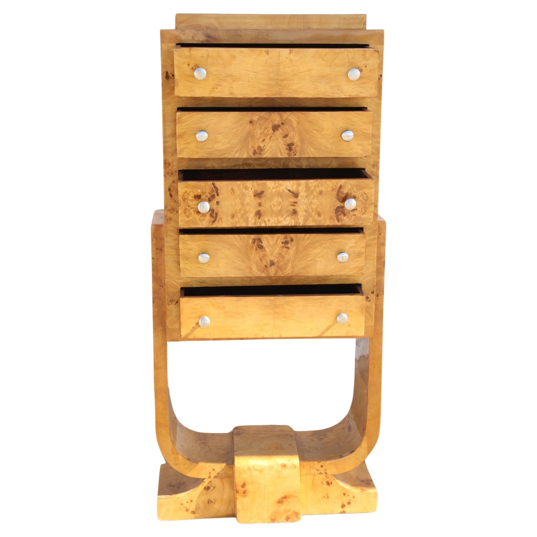 1 beautiful burl wood Art Deco chest. It is  sculptural and highly lacquered to accentuate the beautiful burl of the wood. They have 5 drawers for lots of storage. They rest on a bentwood legs that interlock into the base.

A beautiful addition to