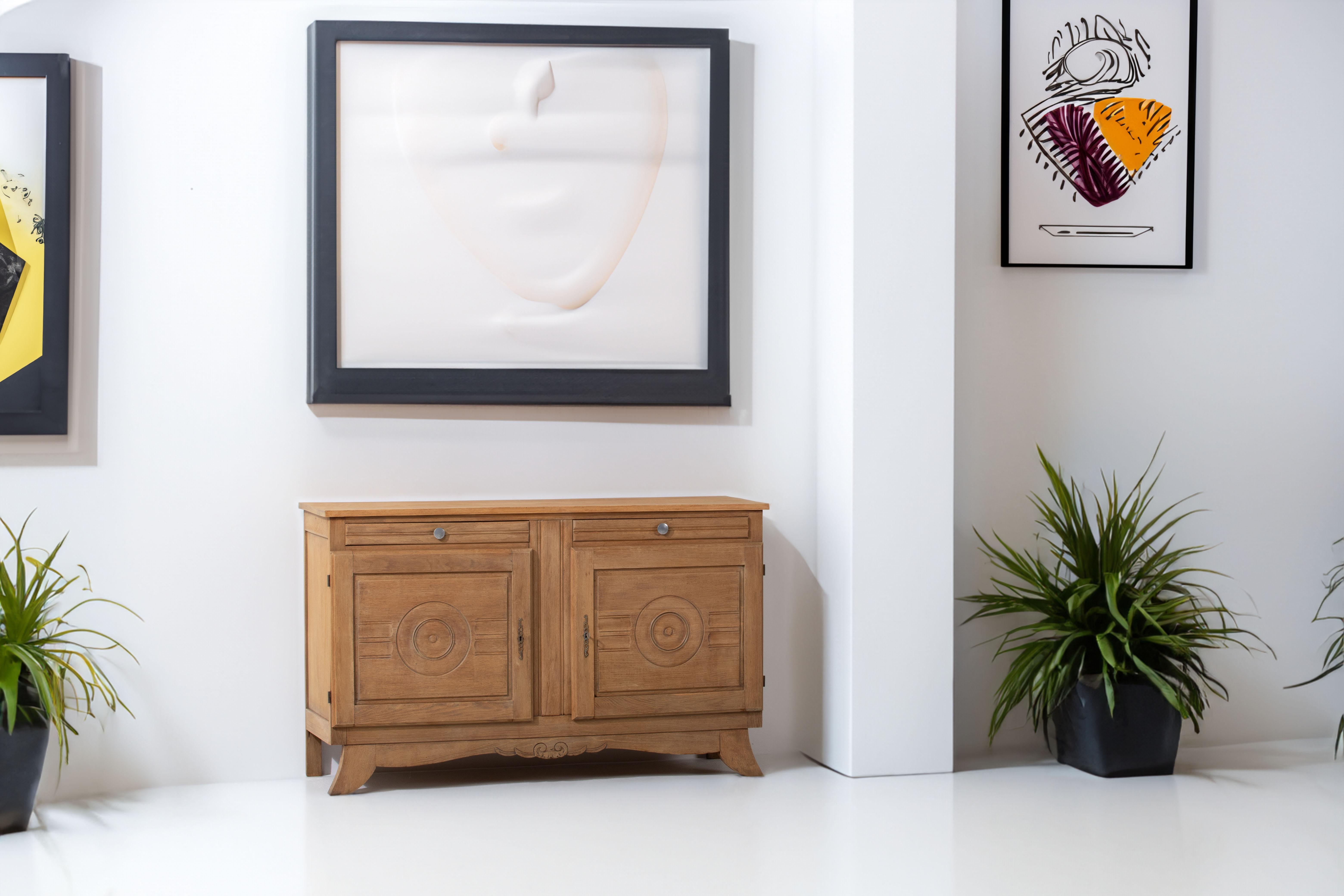 Step back in time to the enchanting world of 1940s France with this exquisite French Provincial oak credenza. Crafted with meticulous attention to detail, this compact piece captures the essence of Art Deco sophistication, reflecting an era