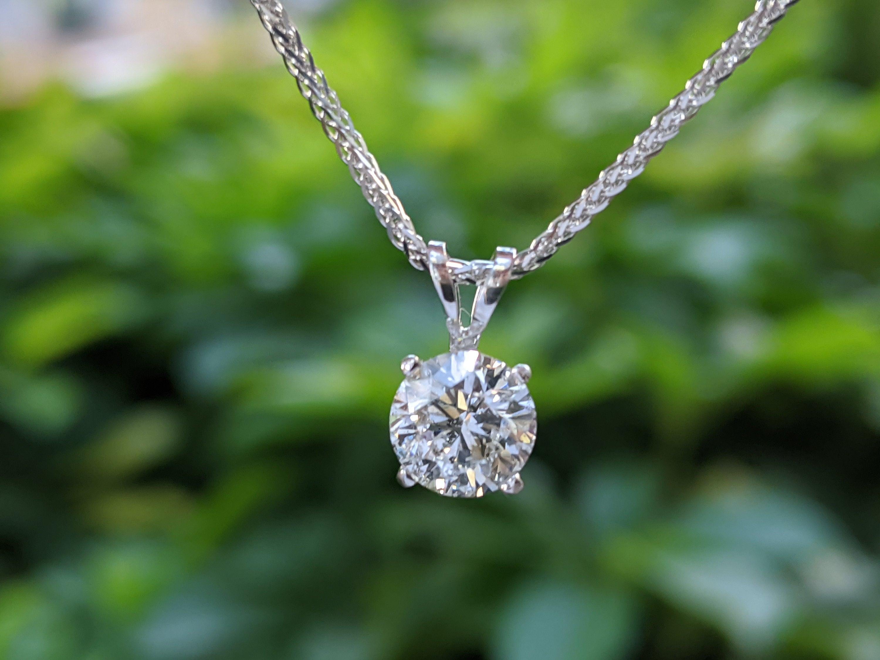 A classic solitaire diamond pendant necklace made of 14K white gold set with a round cut Diamond of 1 carat. The center stone of this handmade pendant necklace is of excellent cut, SI clarity and G color.
 
 Center Stone:Natural Untreated Diamond
