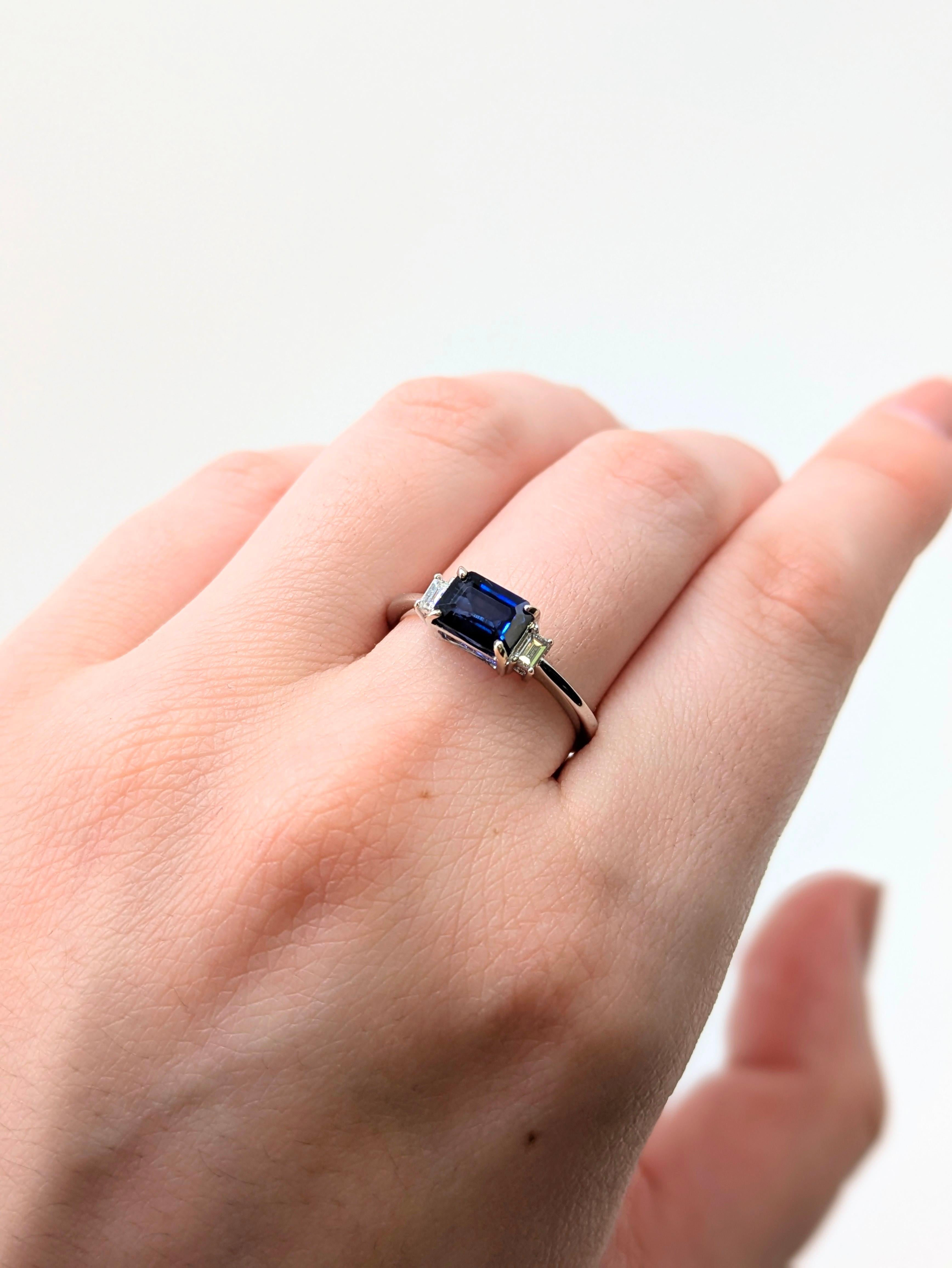 A sleek three-stone ring showcasing a 1.07 carat blue sapphire paired with two natural earth-mined diamonds. Set in polished 14k solid gold, this modern design captures bold color and timeless brilliance in one stunning piece.

**We offer