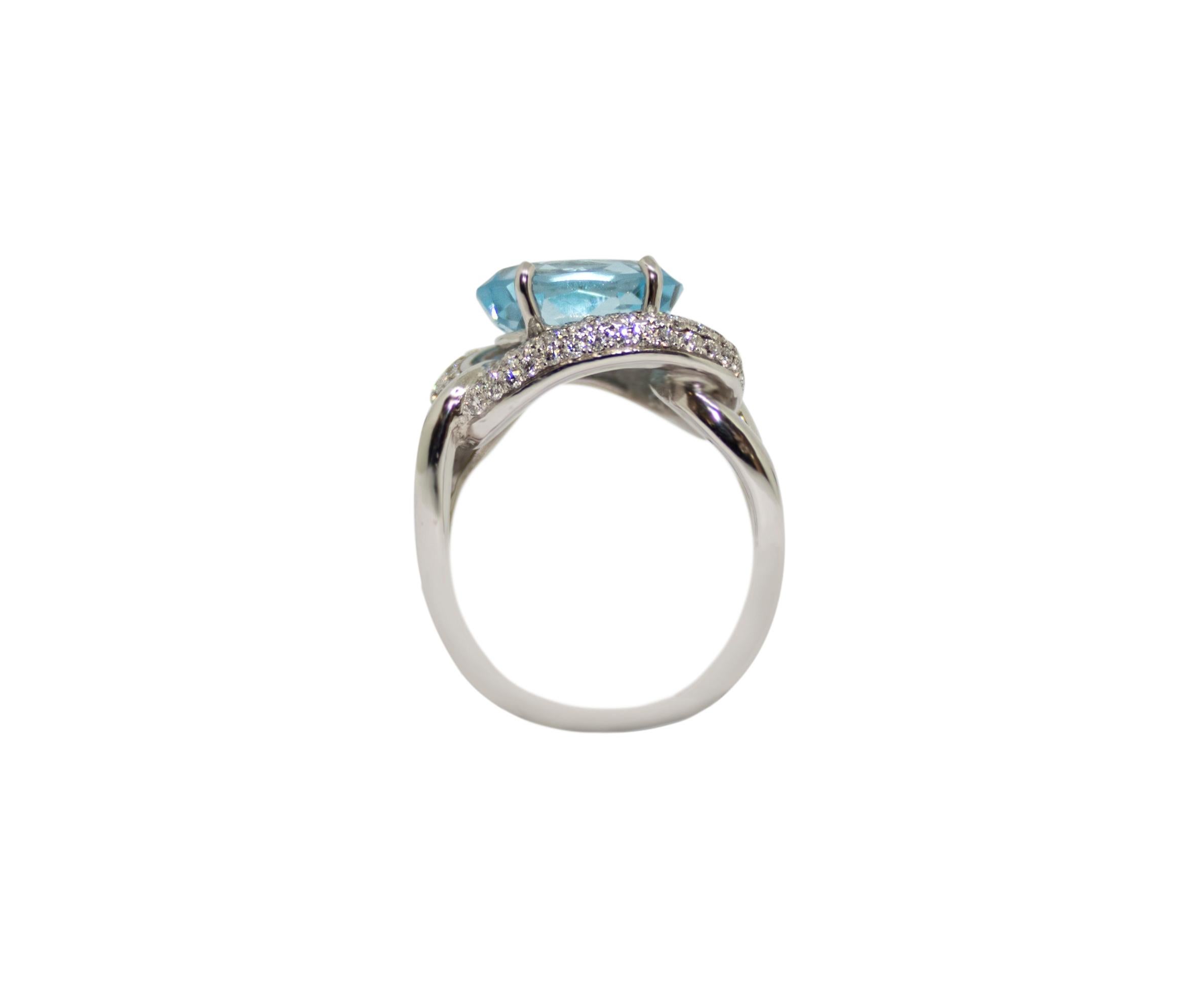 Contemporary 1 Carat Blue Topaz with Diamond Halo Set in an 18 Karat Gold Engagement Ring For Sale