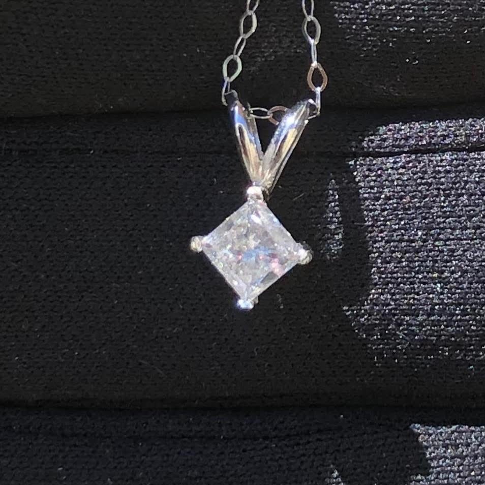Elegant near 1 carat real natural princess diamond pendant in 14k white gold with necklace chain. A center princess cut diamond weighing nearly 1 carat (natural earth-mined diamond) is set in a 4-prong basket.

Diamond solitaire pendant in 14k white