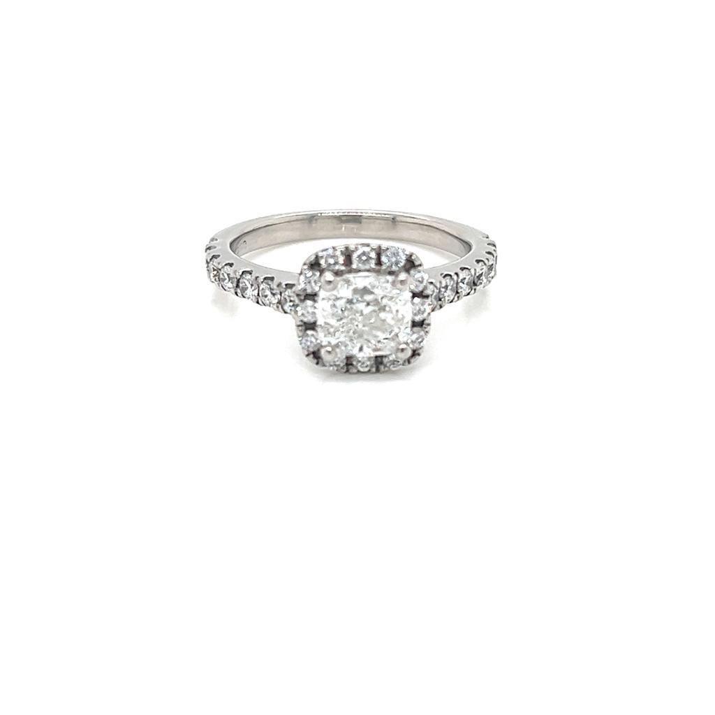 1 Carat Cushion cut Diamond Ring in Platinum.

This alluring ring features a 1 Carat Cushion cut Diamond at its centre, held in a claw setting and surrounded by a halo of round brilliant diamonds on a diamond-encrusted Platinum band.

The Diamond at