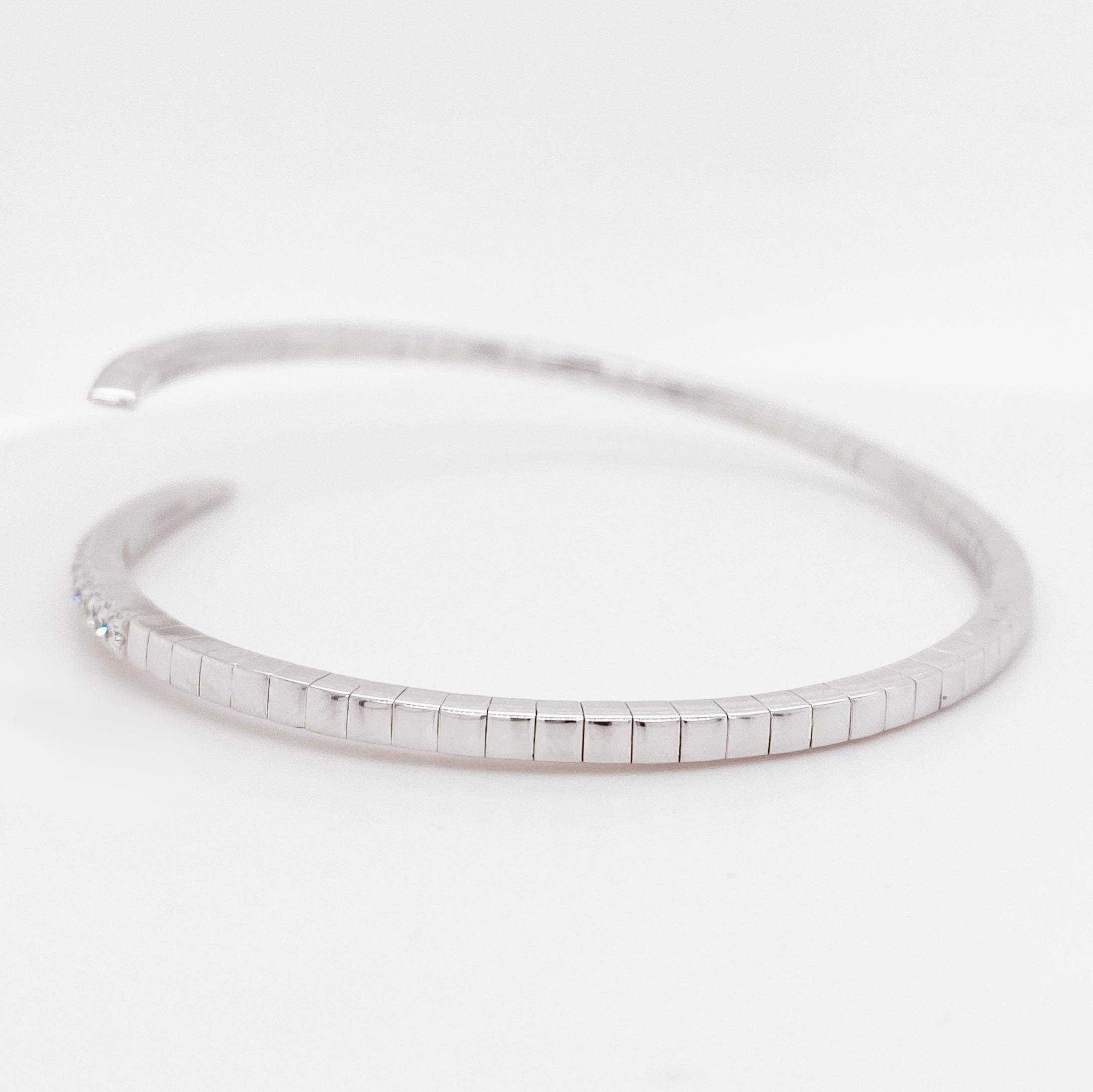 Gorgeous, bypass diamond bangle! The 14k white gold diamond bracelet is a flexible bypass design with .91 carats total diamond weight. The diamond bracelet has an edgy, spiked design that is stunning on its own and can easily be paired with other
