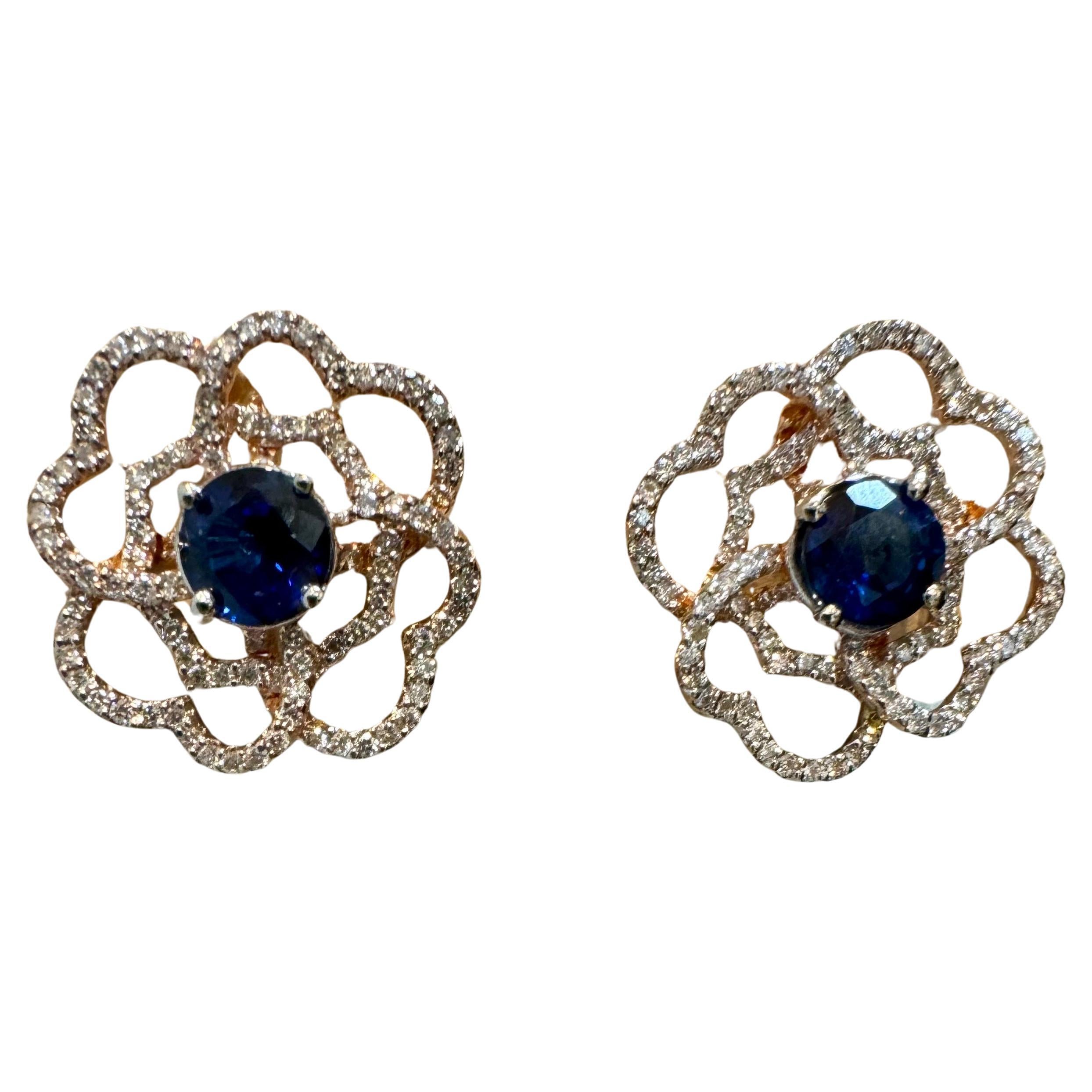 A fabulous pair of earrings with an enormous amount of look and sparkle!
almost 1  carat In the center natural sapphire set in solid 14 karat Rose  gold  with post backs
Cluster earrings, featuring a center 1 ct  round  Sapphire  surrounded by 