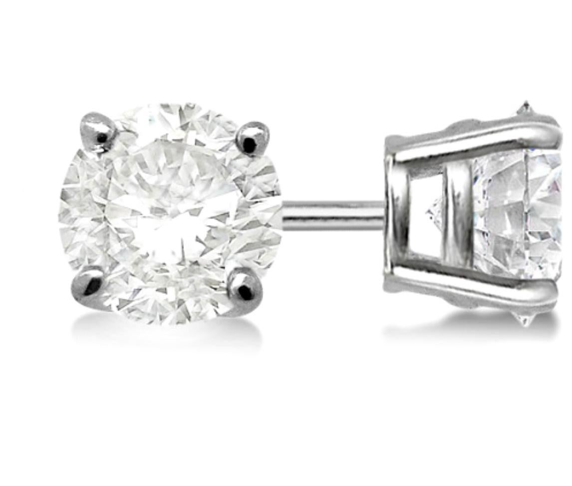 A fabulous pair of earrings with an enormous amount of look and sparkle!
Round Four-prong Basket Diamond Stud Earrings
Over  1  carat VS clarity and G Color diamonds set in solid 14 karat White gold  with post backs
Total Diamond Weight exact 2.04