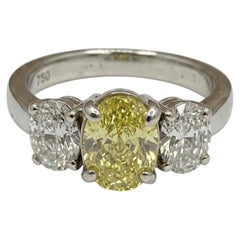 1 Carat Fancy Yellow Diamond Three-Stone Oval Diamond Ring
