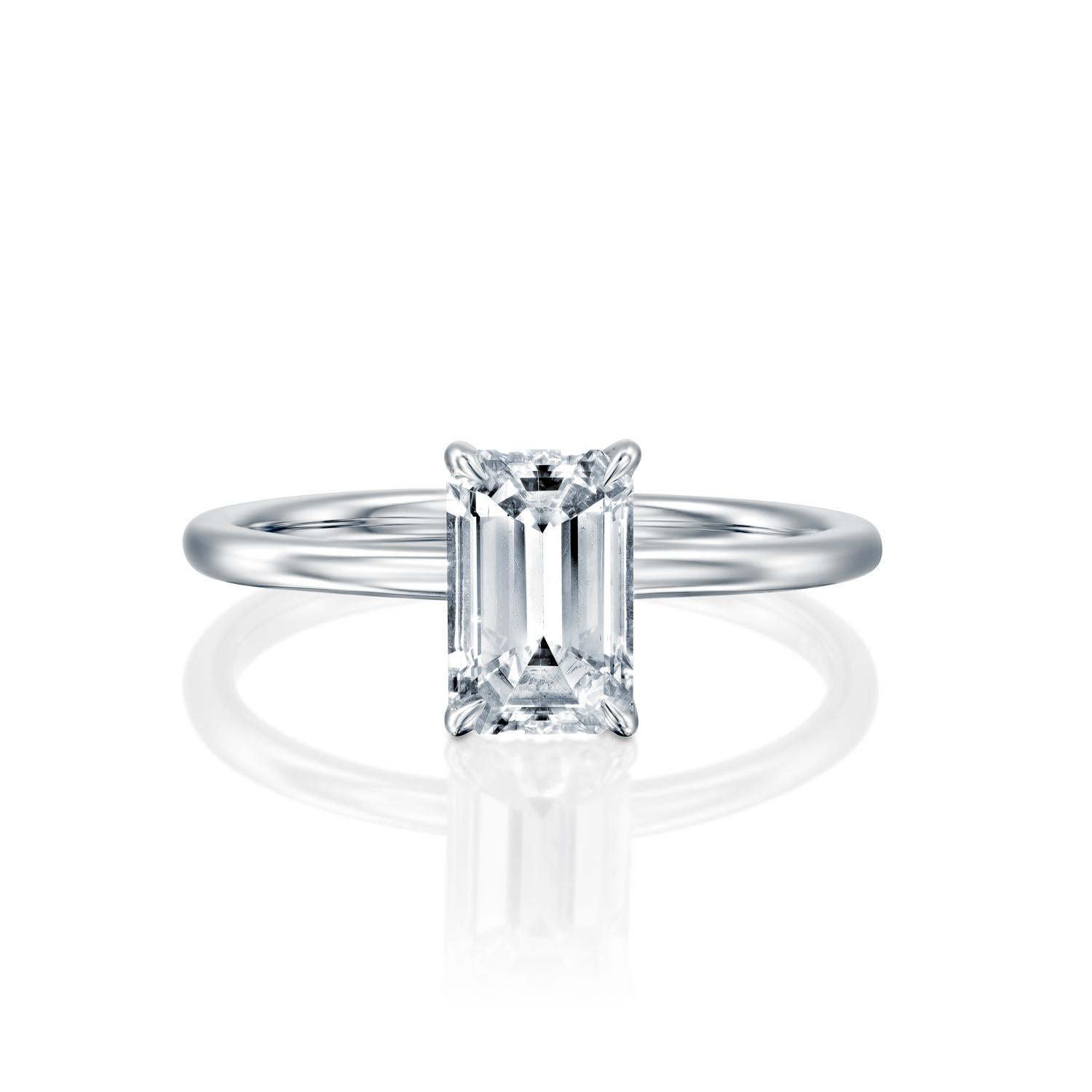 This breathtaking ring features a solitaire GIA certified diamond. Ring features a 1 carat emerald cut 100% eye clean natural diamond of F-G color and VS2-SI1 clarity. Set in a sleek, 18K white gold, solitaire ring with a 4-prong setting, this