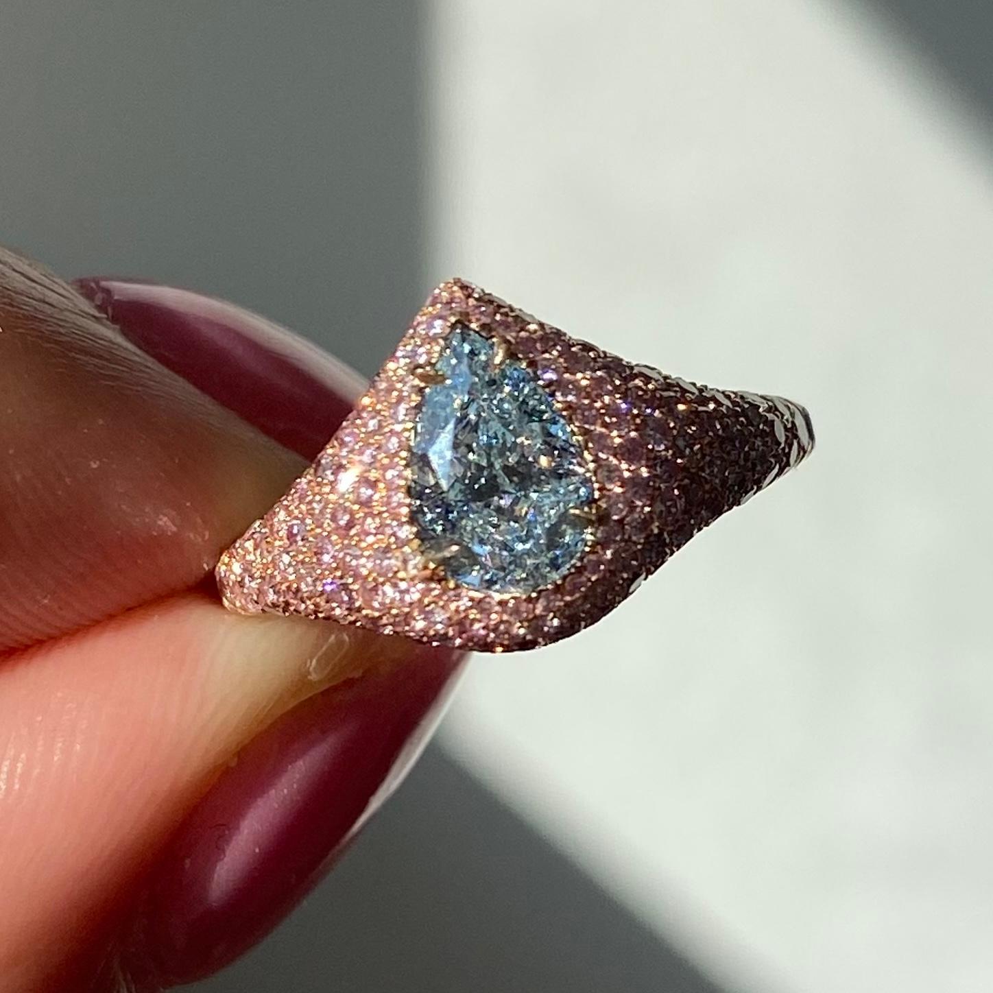 Elegant and beautiful ring with some of the earths rarest specimens- natural blue and pink diamonds

Center stone is a 1ct GIA Light Blue Pear shape with no bow tie, full of life
Rose Gold ring with natural fancy pink round diamonds
This piece can