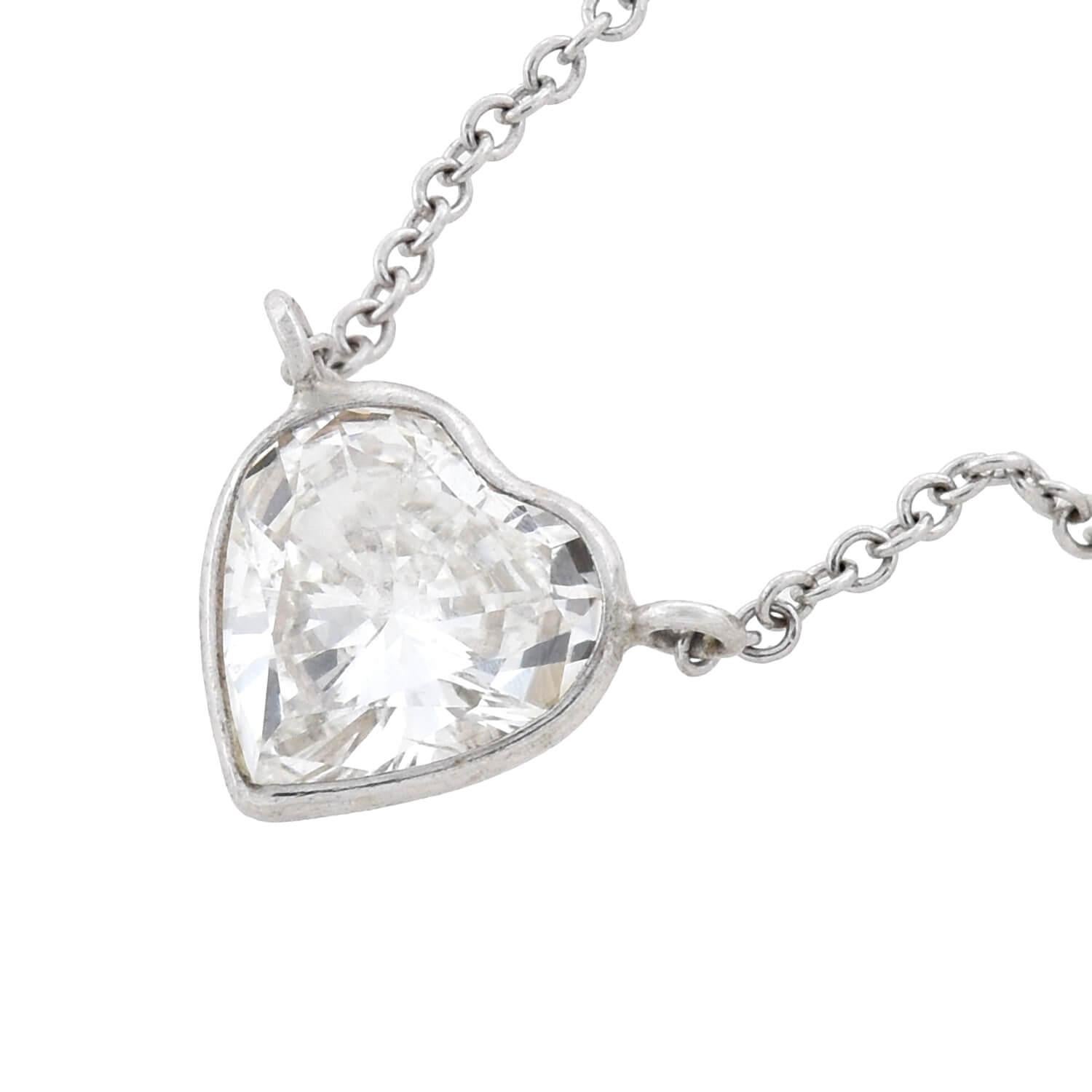 A beautiful and romantic Estate diamond necklace! Crafted in 14kt white gold, this lovely piece is comprised of a single heart-shaped diamond pendant that attaches to a delicate white gold chain. The heart-shaped diamond is bezel set and weighs