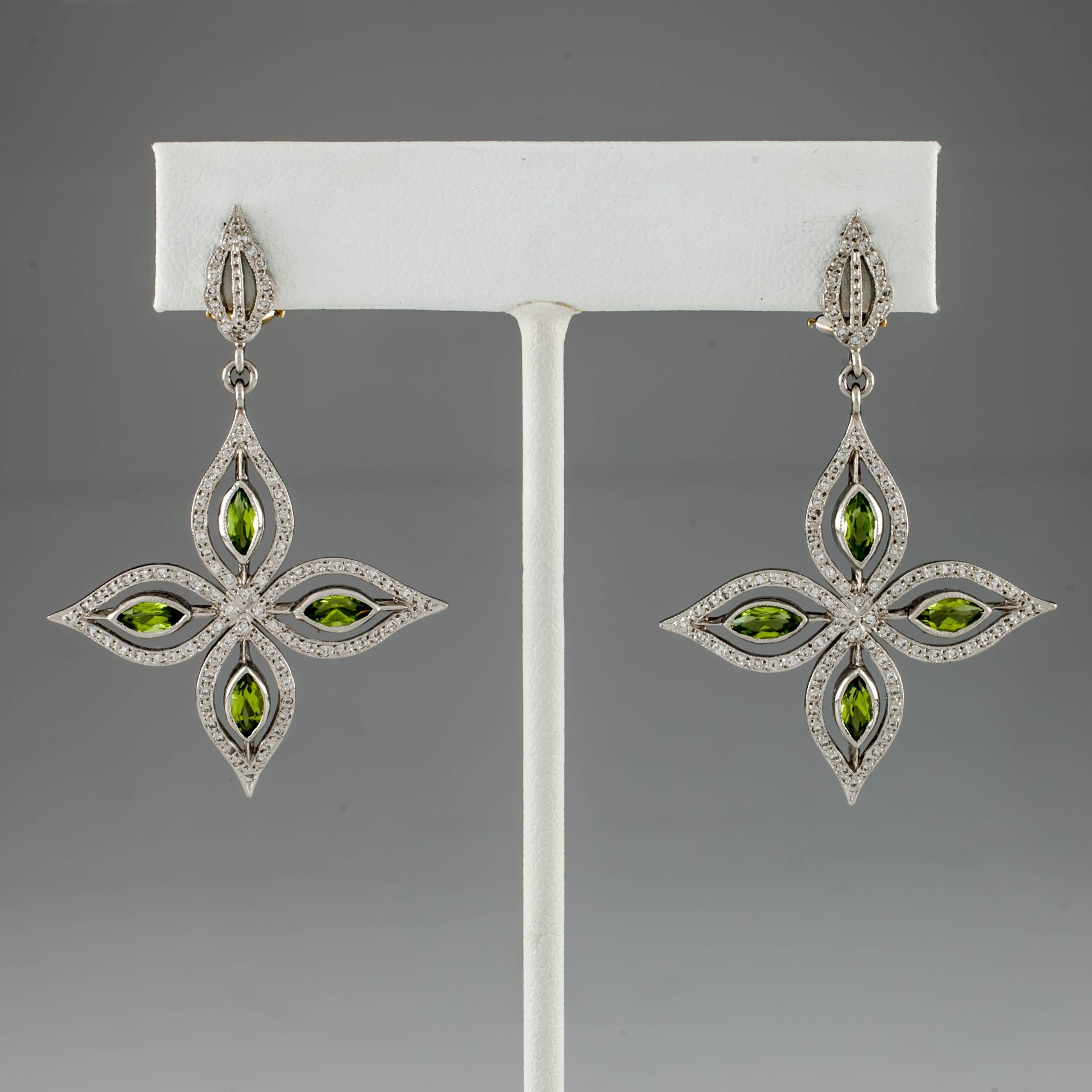 Beautiful Starburst Dangle Earrings
Feature Four Bezel-Set Marquise Peridots surrounded by bezel of round diamonds and milgrain detailing
Average Diamond Color = G - H
Average Clarity = SI
Total Carat Weight of All Stones = 1.0 Cts
Total Length of