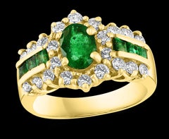 1 Carat Oval Cut Emerald and 1.0 Carat Diamond Ring 18 Karat Yellow Gold