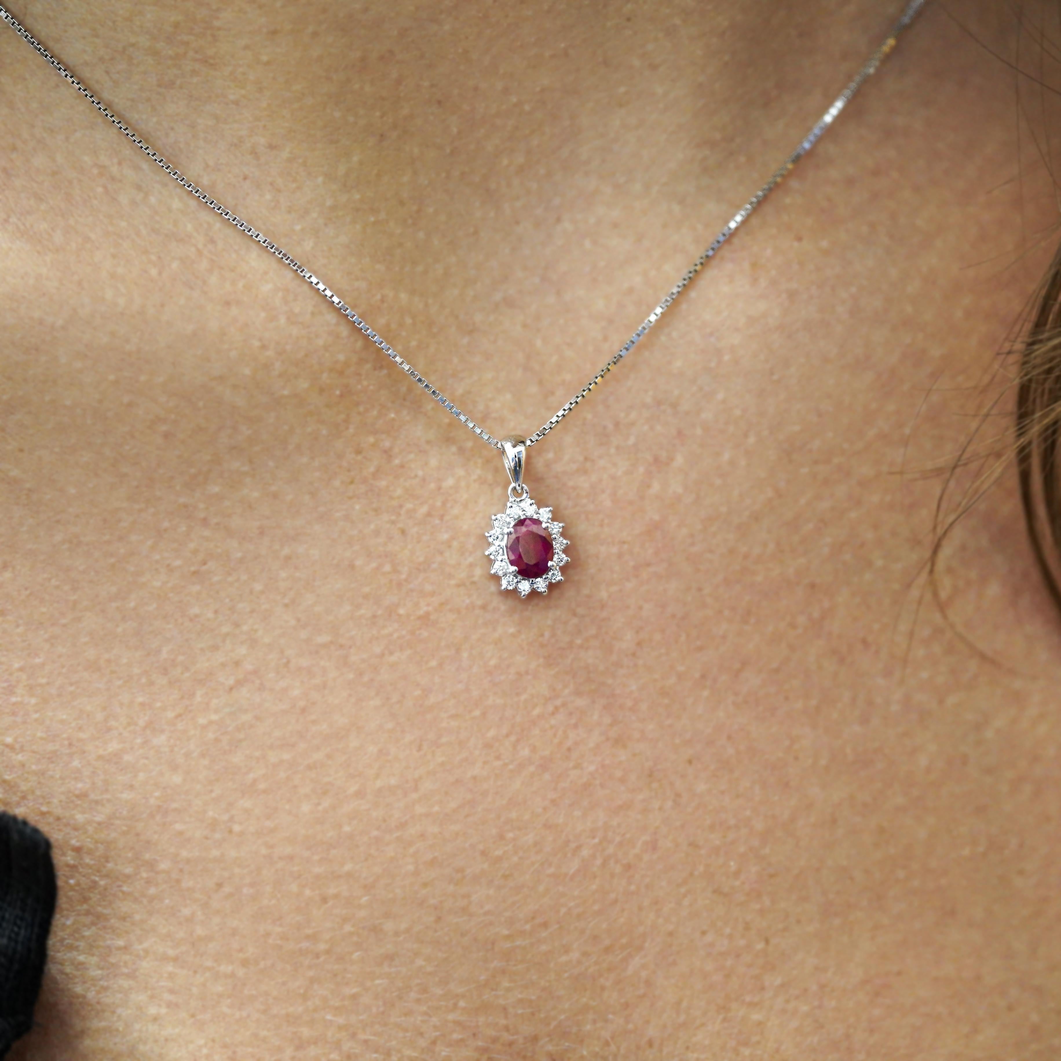 Classically modern 1 carat oval cut natural ruby pendant, set in solid 14K white gold, complemented by 14 round-cut diamonds totaling 0.17ctw. Designed for everyday wear, this pendant is lightweight yet substantial, ensuring a timeless look. The