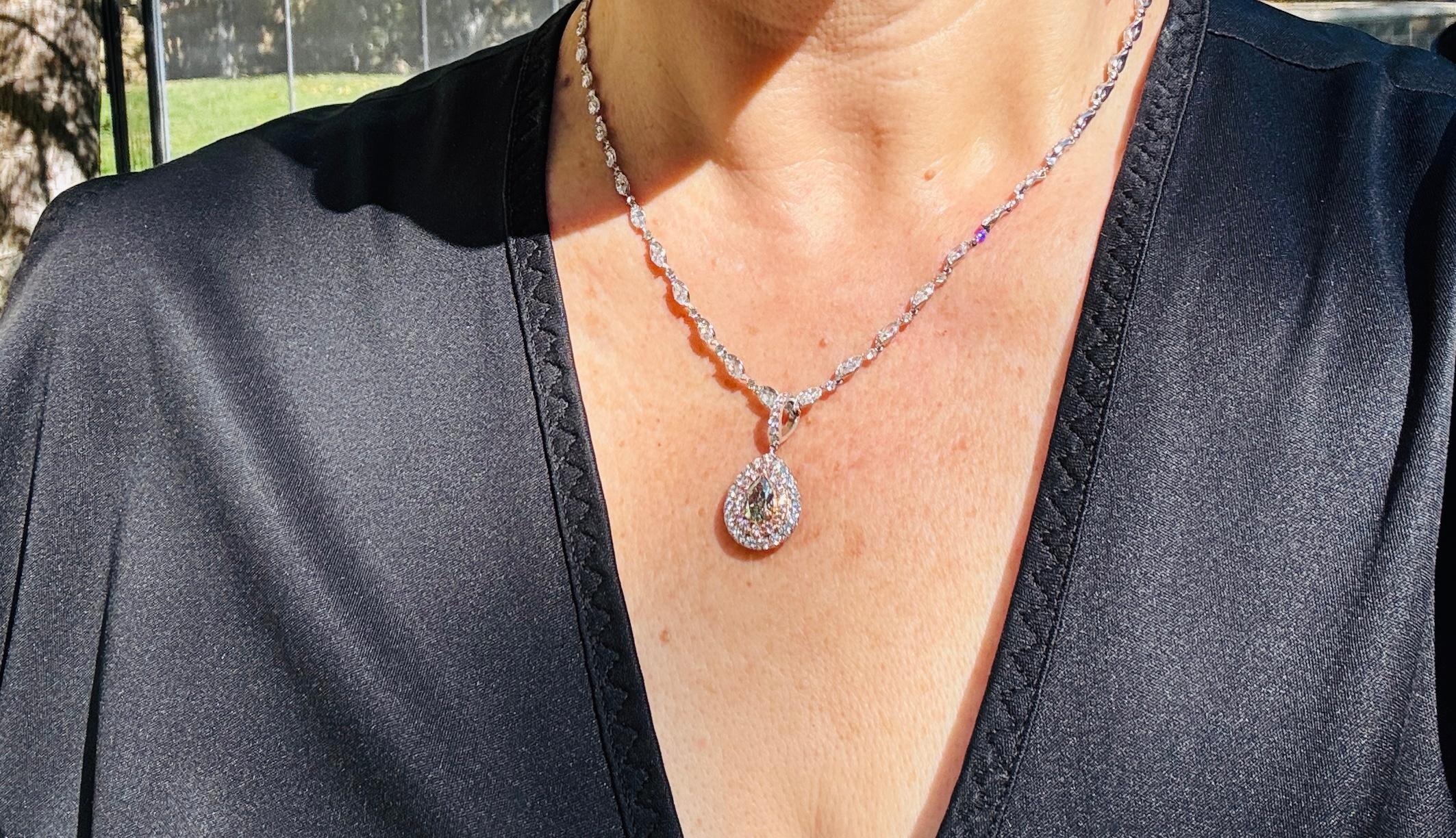 Ti presentiamo uno splendido ciondolo a doppia aureola con al centro un diamante verde chiaro a forma di pera da 1,13 carati certificato GIA, di purezza SI1. Questo design senza tempo mette in risalto l'eleganza della pietra centrale, impreziosita