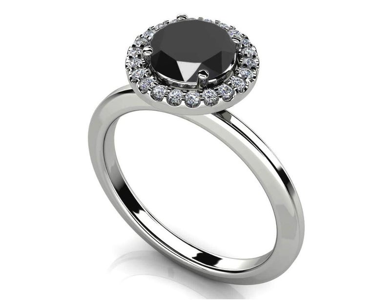 Finely crafted and custom made in brightly polished 14K White Gold, this spectacular engagement ring features a fine black diamond which measures 6.00 x 6.05 x 4.00 mm and weighs 1 carats. This center stone is accented by approximately 0.27 carats