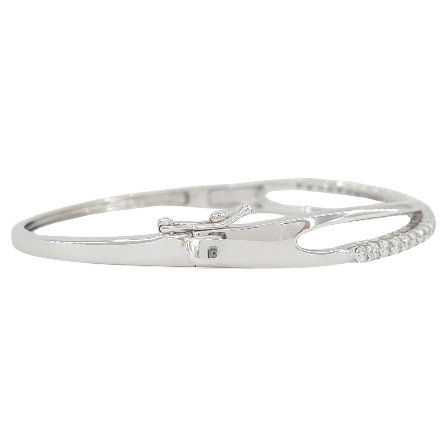 1ct total weight Round Brilliant Cut Diamond 14k White Gold Bangle Bracelet. 

The bracelet weighs 12.2 grams, 7 inches in length, 6mm wide, 3.3 mm thick, there are 31 natural Round Brilliant Cut diamonds weighing approximately 1 ct total weight,