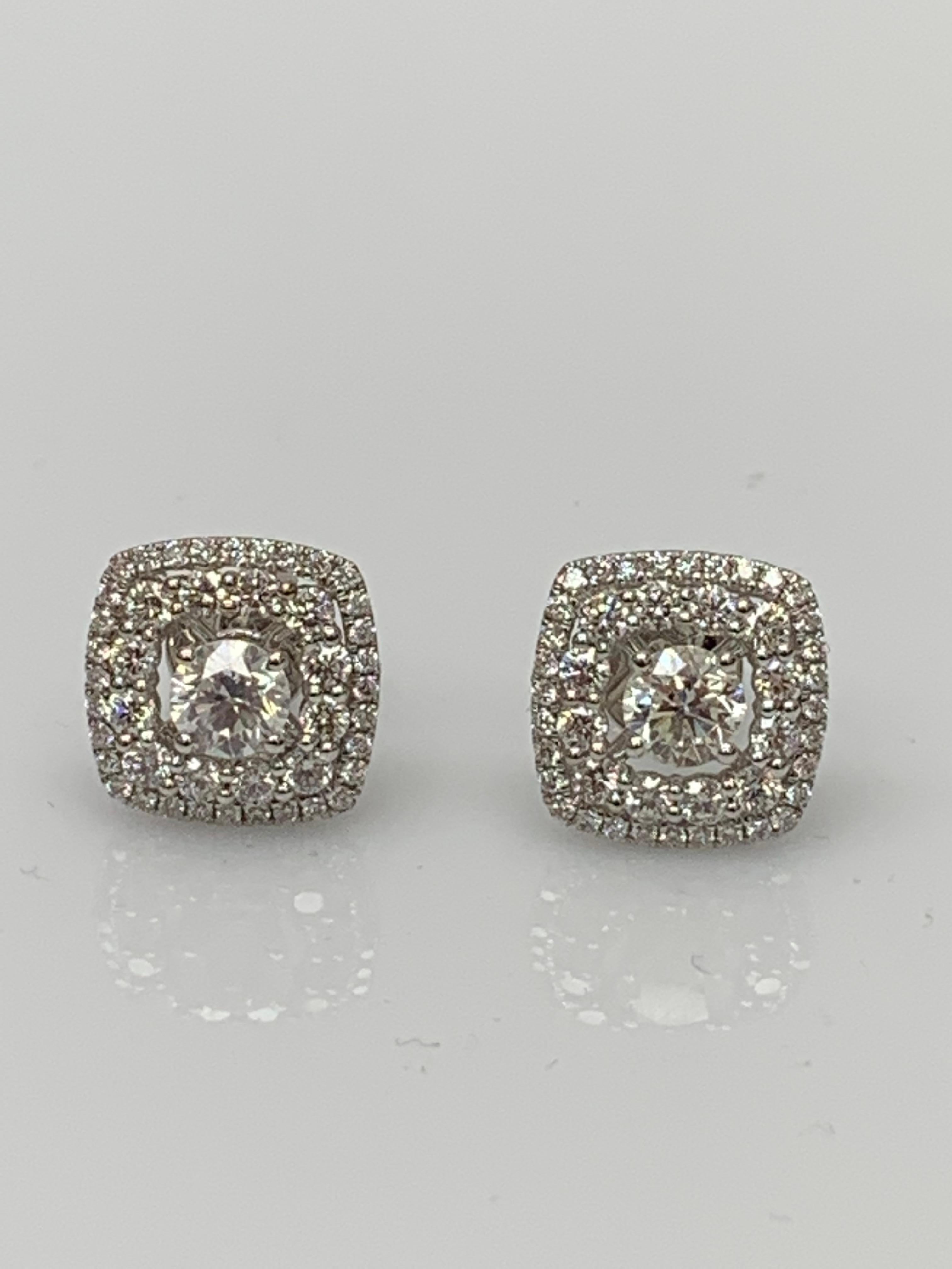 Une paire de boucles d'oreilles simples mettant en valeur 1 carat de diamants brillants ronds de taille 2, entourés d'une double rangée de 88 diamants brillants ronds pesant 1,12 carat et réalisés en or blanc 18 carats.