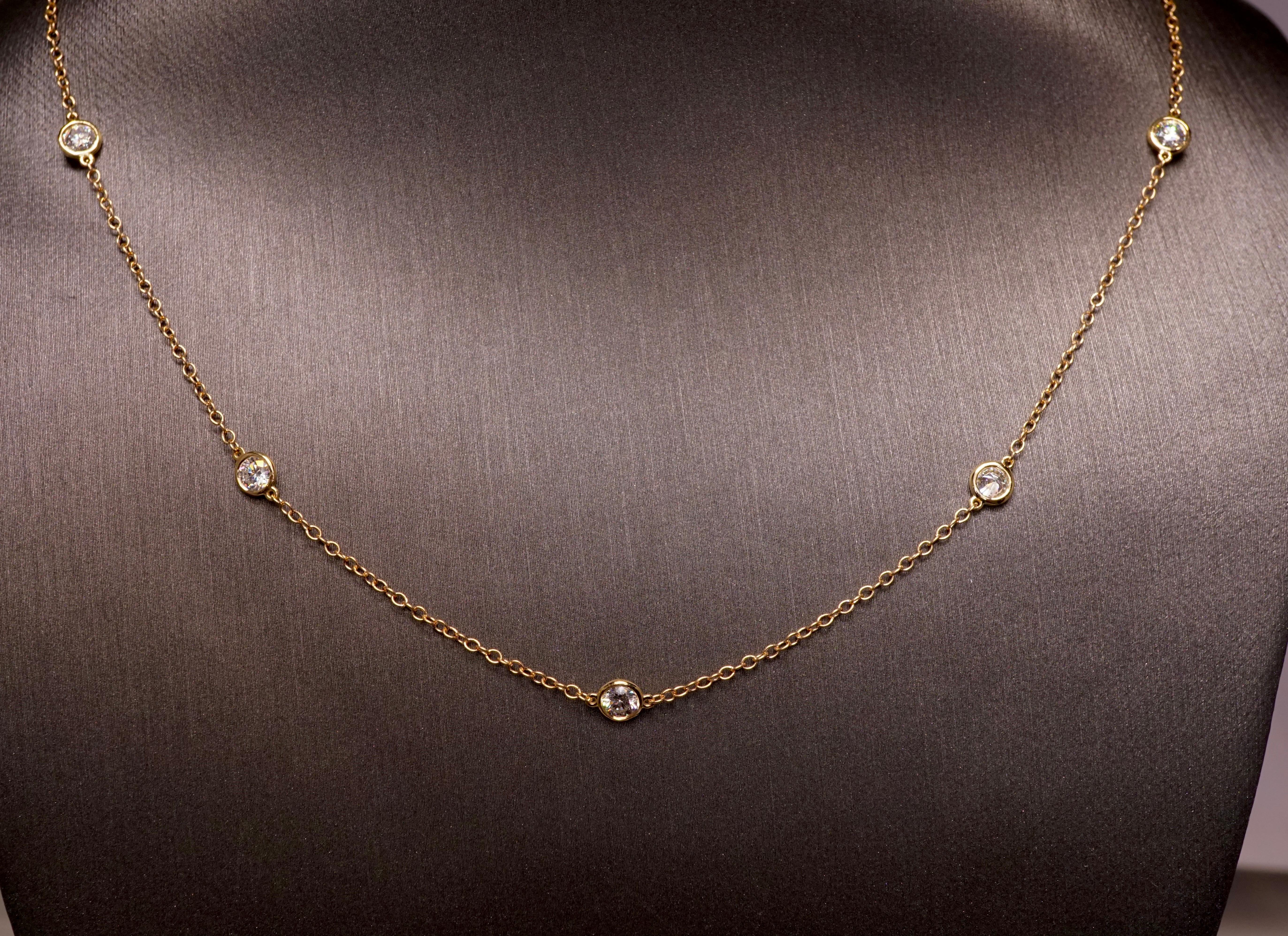 Round cut diamond necklace with 5 bezel set round diamonds set in 14K Yellow gold. Round Brilliant diamonds are F-G VS2-SI1 . Total Carat weight = .80ct. Total weight 1.8 grams. Length is 16