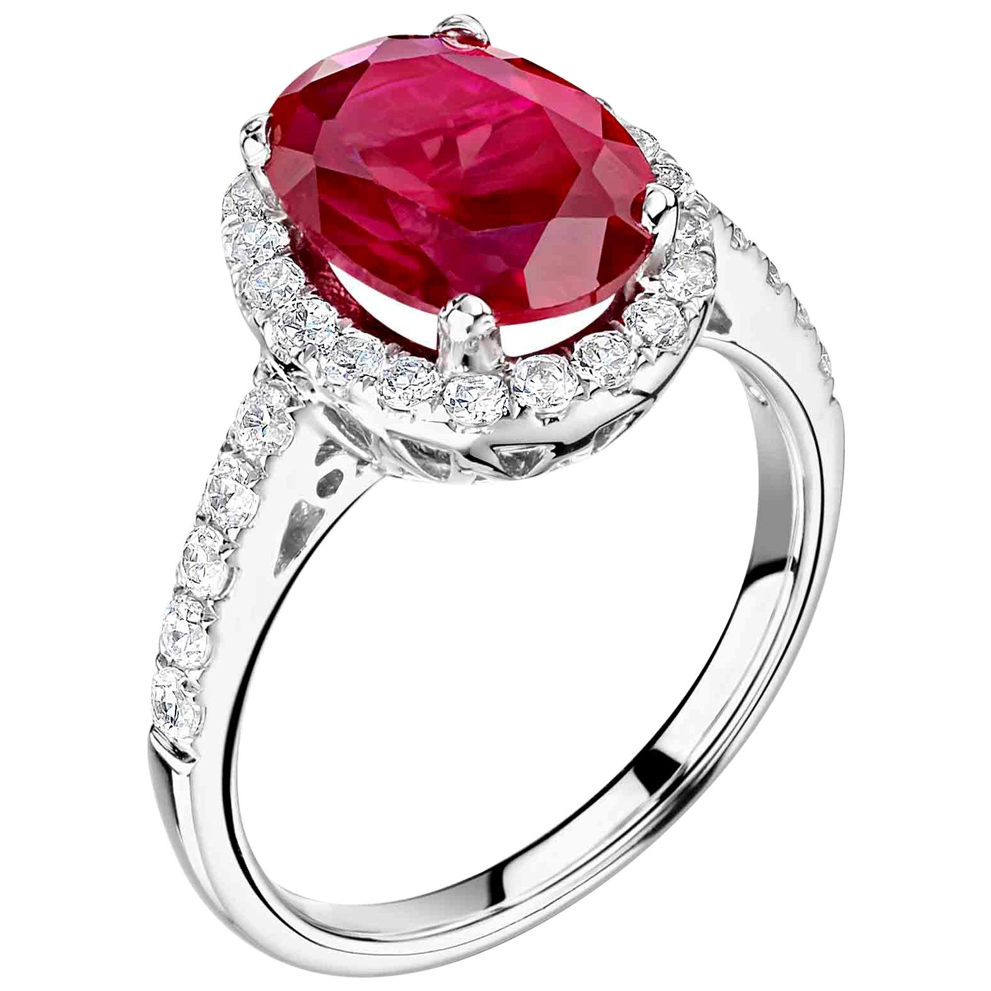 Ideal as an engagement or cocktail ring, this is an example of a bespoke design featuring a diamond halo and diamond flanks.  It is available in 18K white gold or platinum 950.  The centre stone is a ruby and we would recommend one of between 1-2