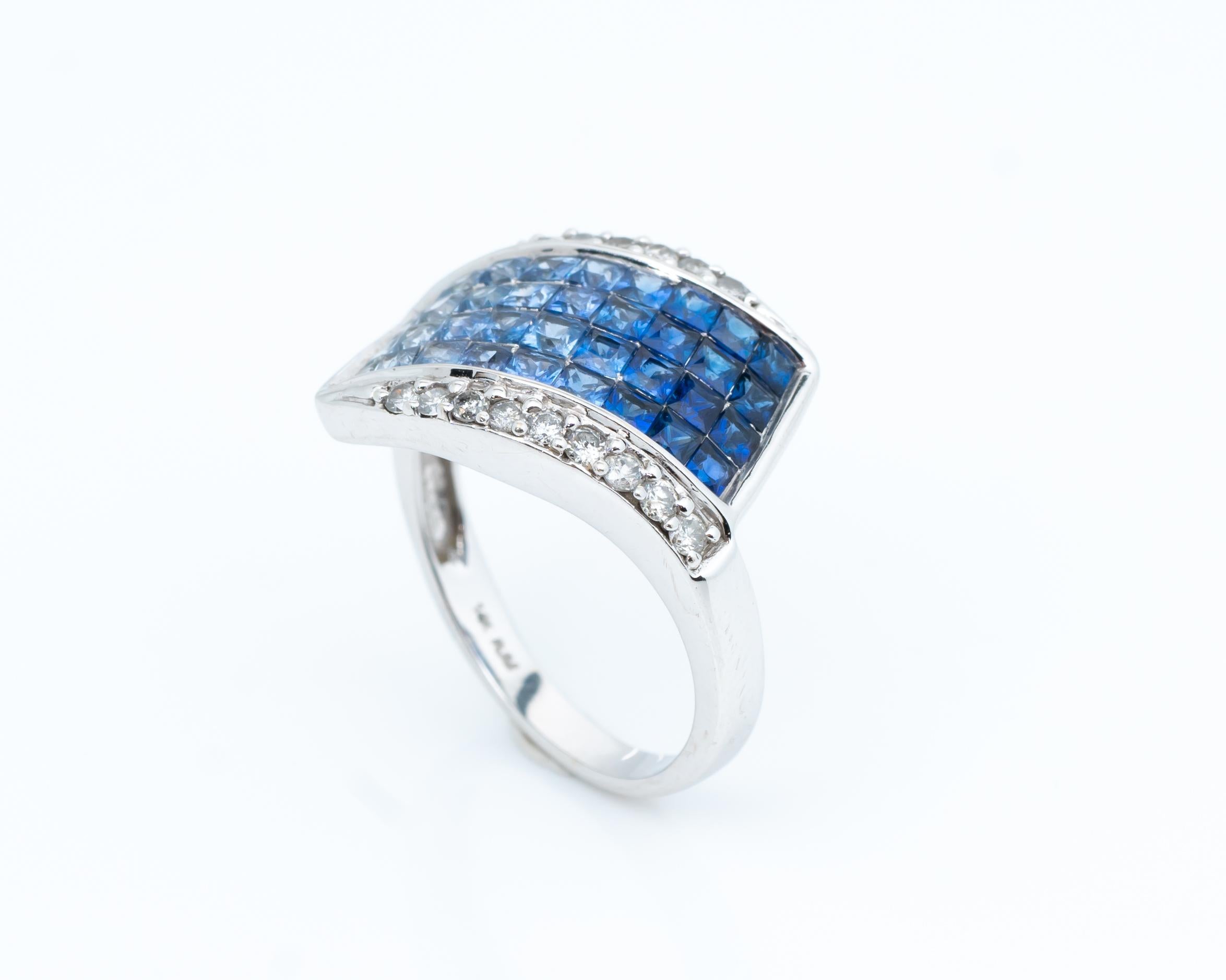 Unique 14 Karat White Gold Ring featuring Sapphires and Diamonds
Sapphires fade from light blue to dark blue, total 1 carats
Hallmarked 14K

Ring Details:
Weight: 4.92
Gold: 14 karat white gold
Size: 6

Diamond Details:
Carat: .15 carat total 
Cut: