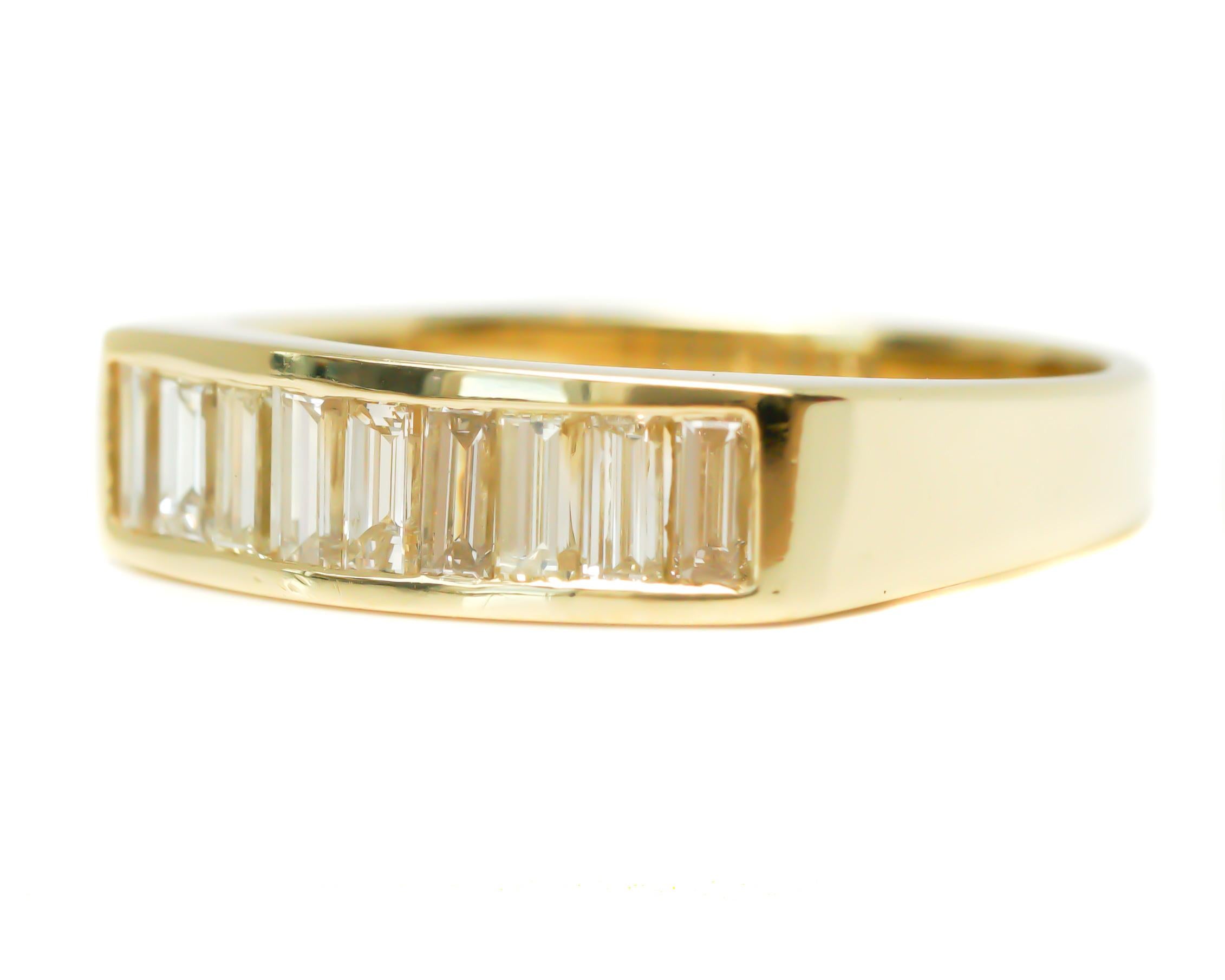 Diamond Band Ring - 18 Karat Yellow Gold, Diamonds

Features:
1.0 carat total Emerald cut, Nearly Flawless Diamonds
18 karat Yellow Gold
Band width tapers from 5.75 - 3.25 millimeters
Finger to top of ring measures 2.5 millimeters
Ring fits a size
