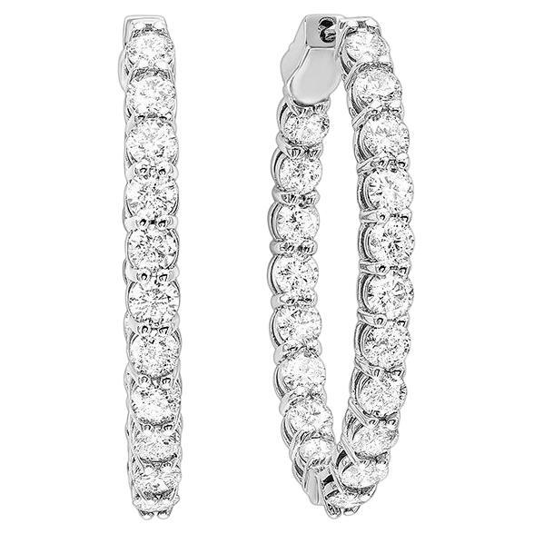 Nothing says luxury like an incredible pair of diamond hoop earrings. These stunning brightly polished 14 karat white gold inside out oval-shaped hoop earrings feature a total of 40 round brilliant cut diamonds totaling 1.00 carats are prong set on