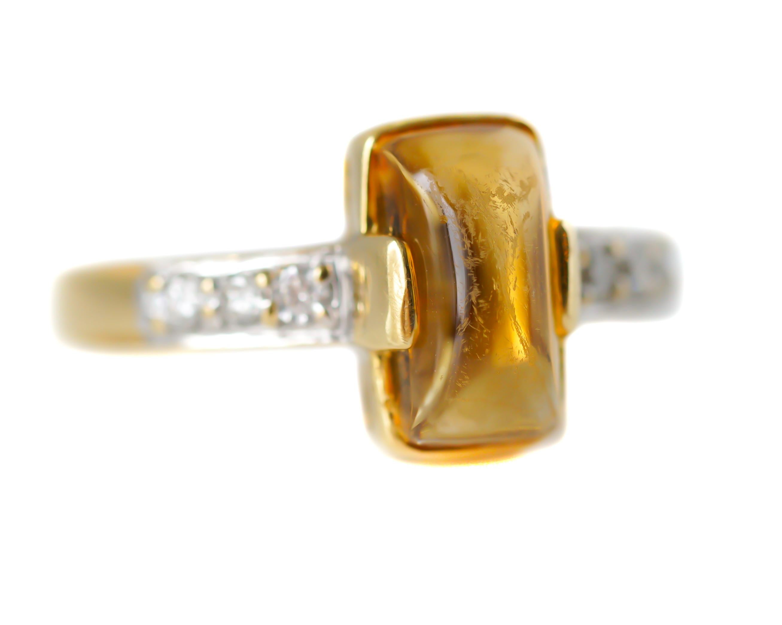 This beautiful 18 karat yellow gold ring features a 1 Carat Yellow Sapphire cabochon center stone with 0.08 carat total Round Brilliant Diamond-set shoulders. The rich 18 karat gold elegantly accents the gorgeous gemstones, brightening the diamonds