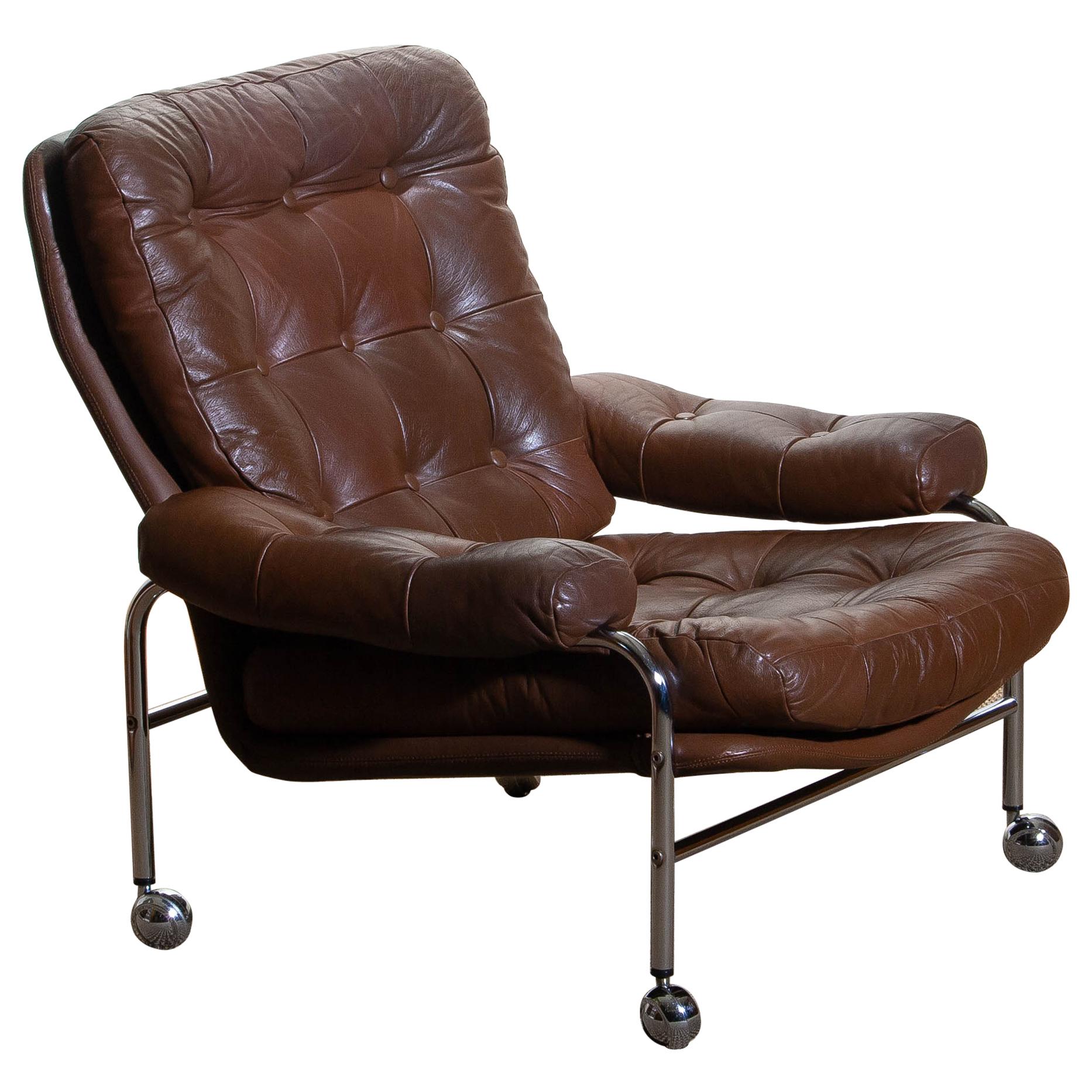 Extremely comfortable easy or lounge chair made by Scapa Rydaholm, Sweden.
This, typical Scandinavian chair is upholstered with brown leather based on a chromed metal frame.
All in perfect condition.
Note: We have two chairs on stock!
 