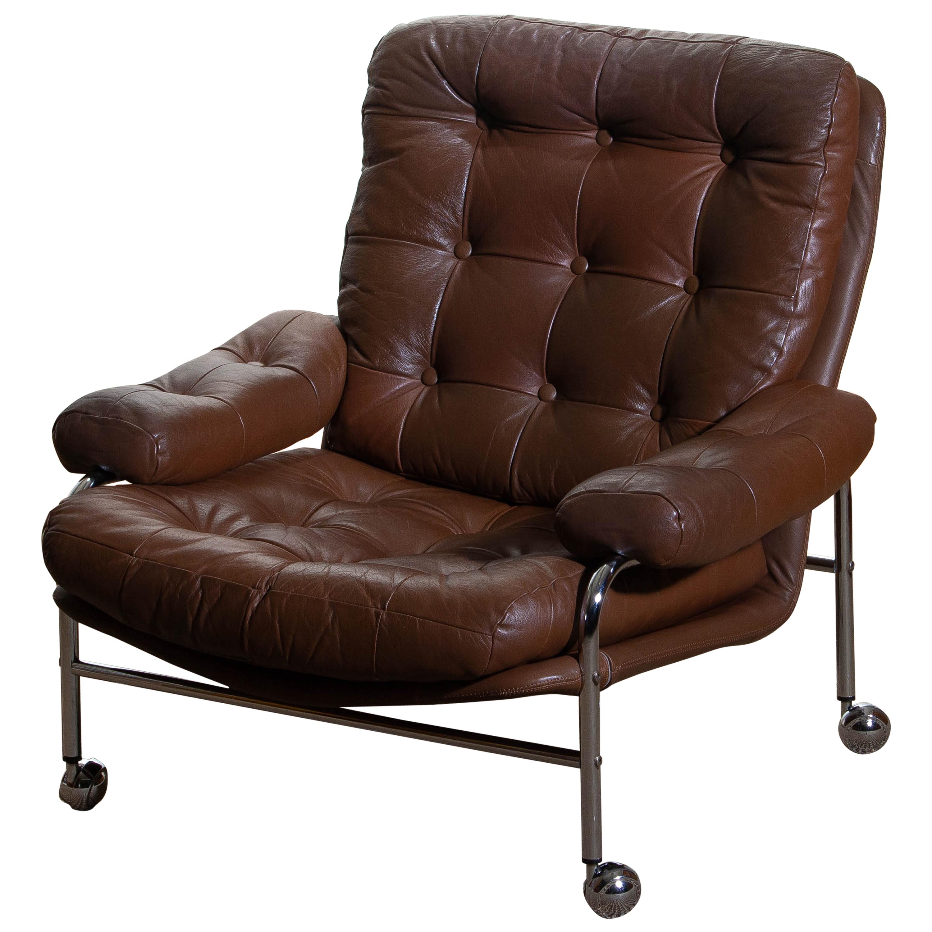 Extremely comfortable easy or lounge chair made by Scapa Rydaholm, Sweden.
This, typical Scandinavian chair is upholstered with brown leather based on a chromed metal frame.
All in perfect condition.
Note: We have two chairs on stock!
   
