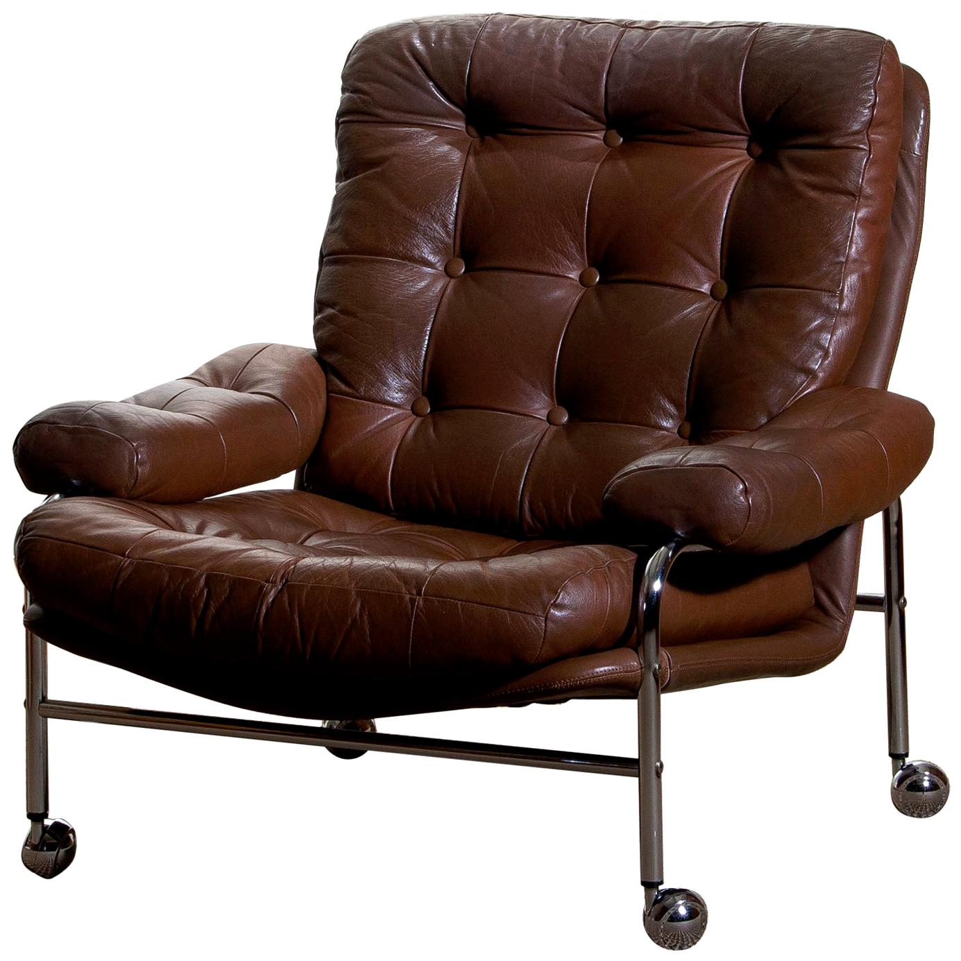 Extremely comfortable easy or lounge chair made by Scapa Rydaholm, Sweden.
This, typical Scandinavian chair is upholstered with brown leather based on a chromed metal frame.
All in perfect condition.
Note: We have two chairs on stock! 
   