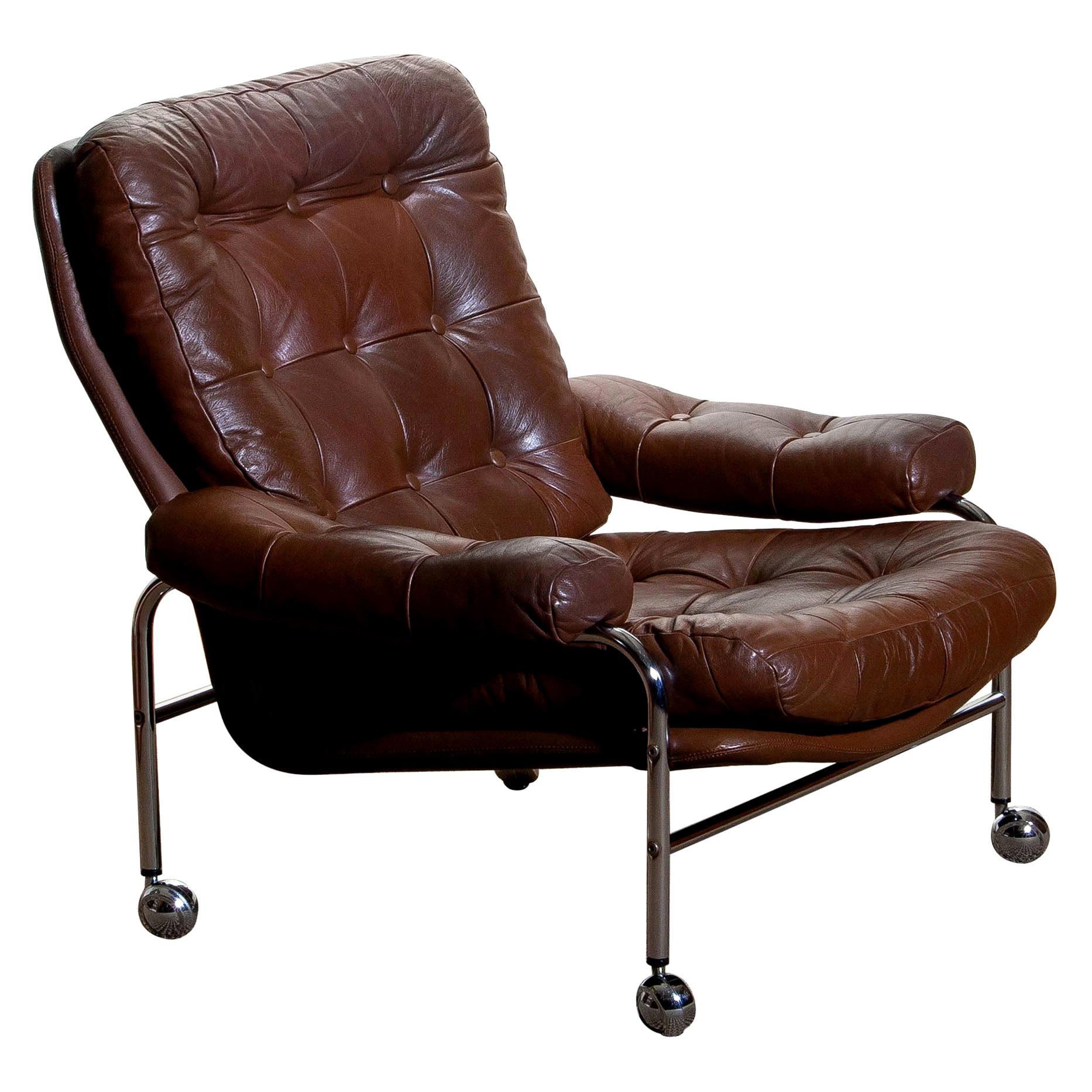 Extremely comfortable easy or lounge chair made by Scapa Rydaholm, Sweden.
This, typical Scandinavian chair is upholstered with brown leather based on a chromed metal frame.
All in perfect condition.
Note: We have two chairs on stock!
       