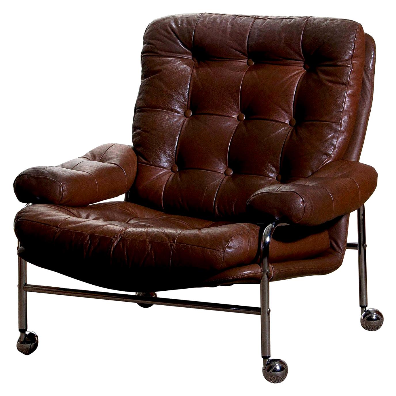 Extremely comfortable easy or lounge chair made by Scapa Rydaholm, Sweden.
This, typical Scandinavian chair is upholstered with brown leather based on a chromed metal frame.
All in perfect condition.
Note: We have two chairs on stock!
  