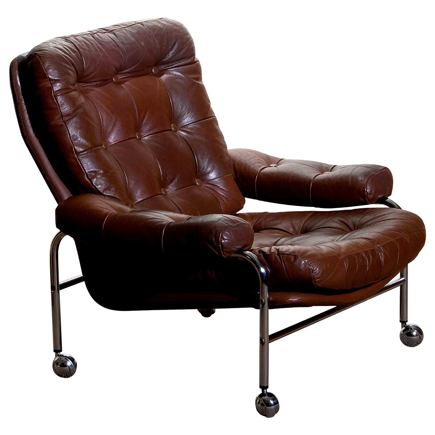Extremely comfortable easy or lounge chair made by Scapa Rydaholm, Sweden.
This, typical Scandinavian chair is upholstered with brown leather based on a chromed metal frame.
All in perfect condition.
Note: We have two chairs on stock!
 