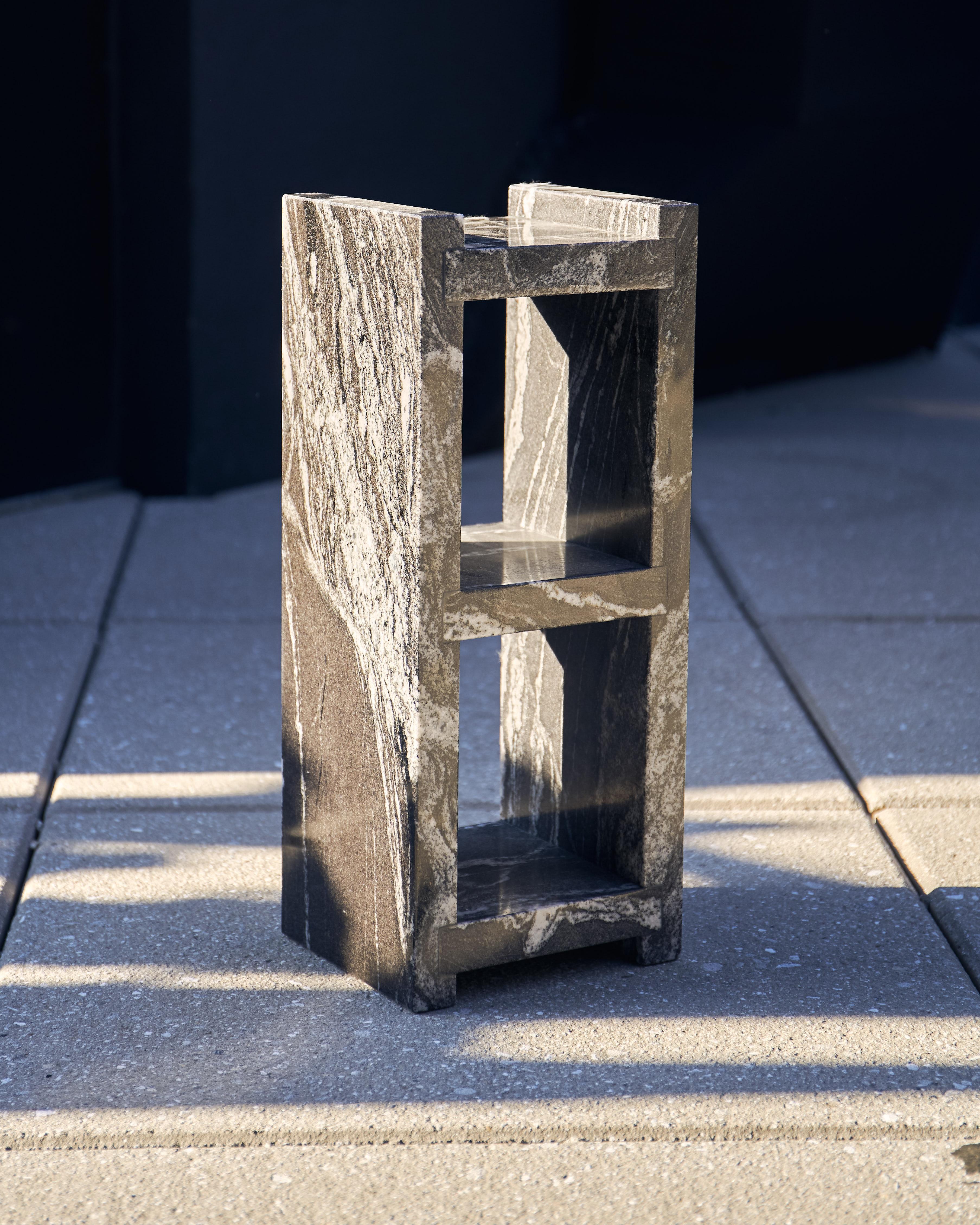 1 water jet cut, hand-polished nero marquina marble block, supporting a tempered glass table top.
Starphire glass top.
Modular.
Made to order in nyc.

Dimensions
Cinder Block length 18.75?
Cinder block width 7.5” 
Cinder block thickness