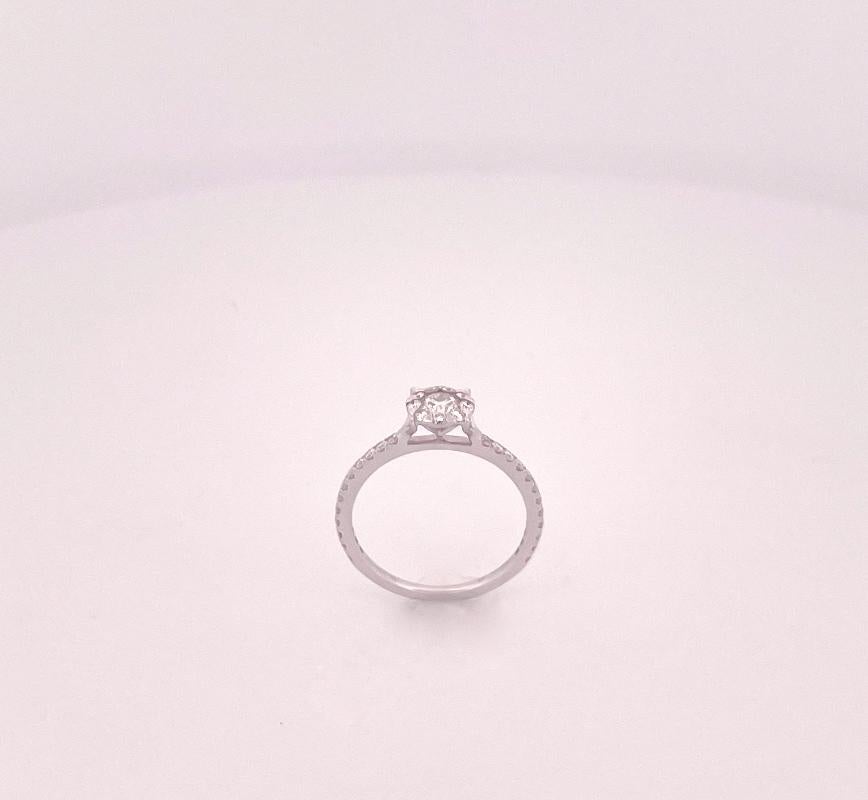From the Eiseman Collection, 18 karat white gold engagement ring featuring a 1 carat center round brilliant cut diamond. This engagement ring is also crafted with 9 round brilliant cut diamonds and 24 round brilliant cut diamonds with a combined