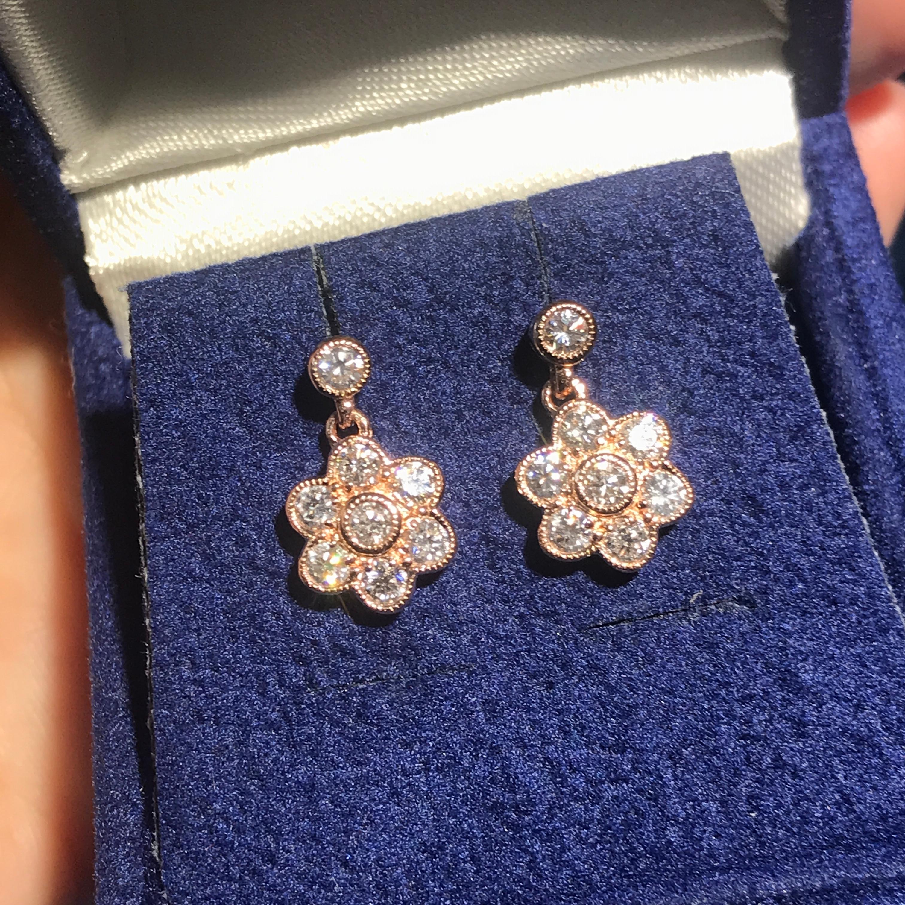 Sparkling round diamonds resembles brilliant flowers in each of these elegant drop earrings for her. Styled in 14k rose gold, the earrings have an approximate total diamond weight of 1 carat and are secure with butterfly backs.

Earrings