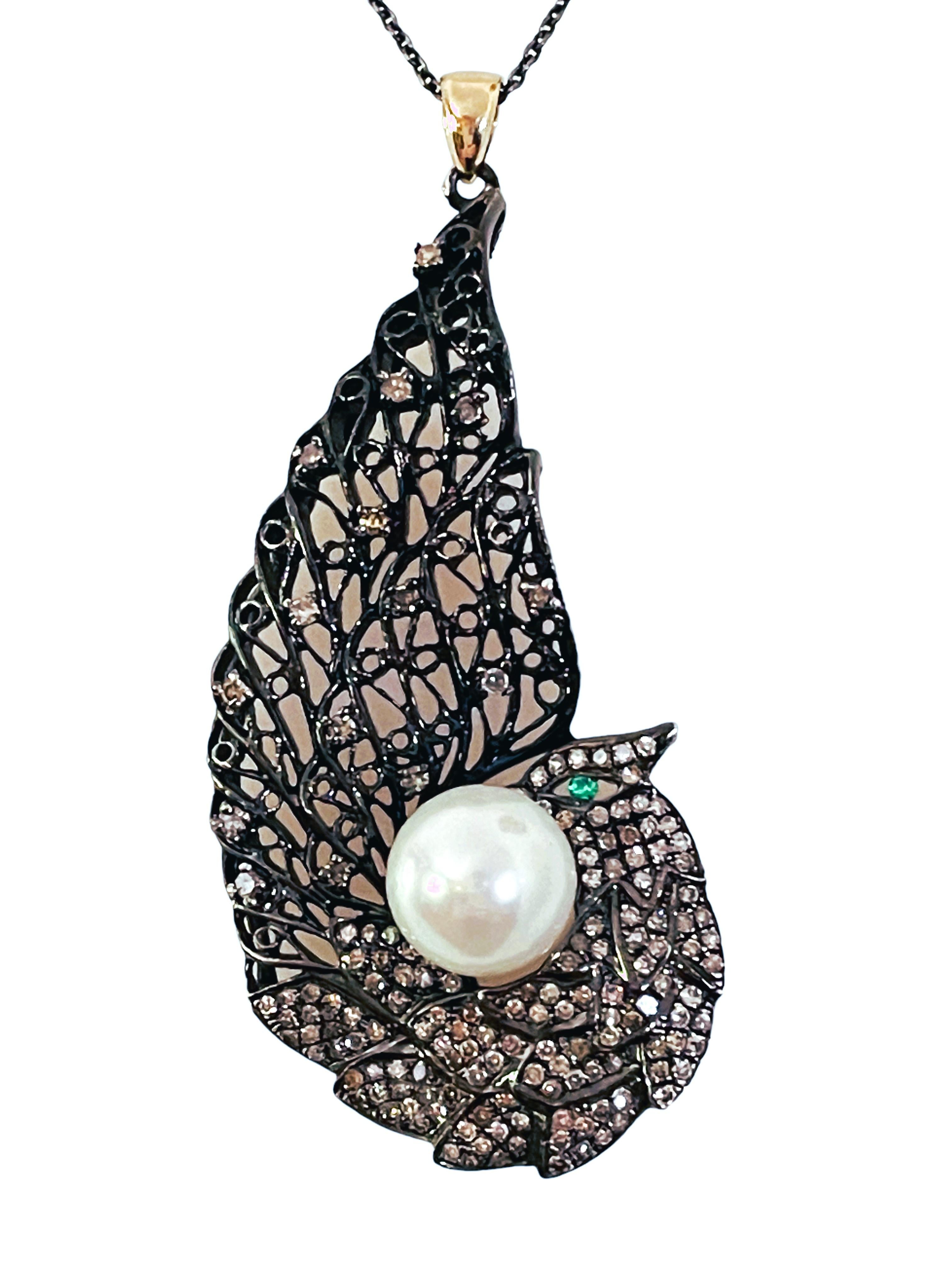This is such a cool necklace.  It is Sterling Silver and Rhodium Plated.  The bail, however, is 14k Yellow Gold.  There are 1 carats of diamonds on this beautiful Peacock pendant along with an Emerald for the eye and a center pearl.  The Emerald is