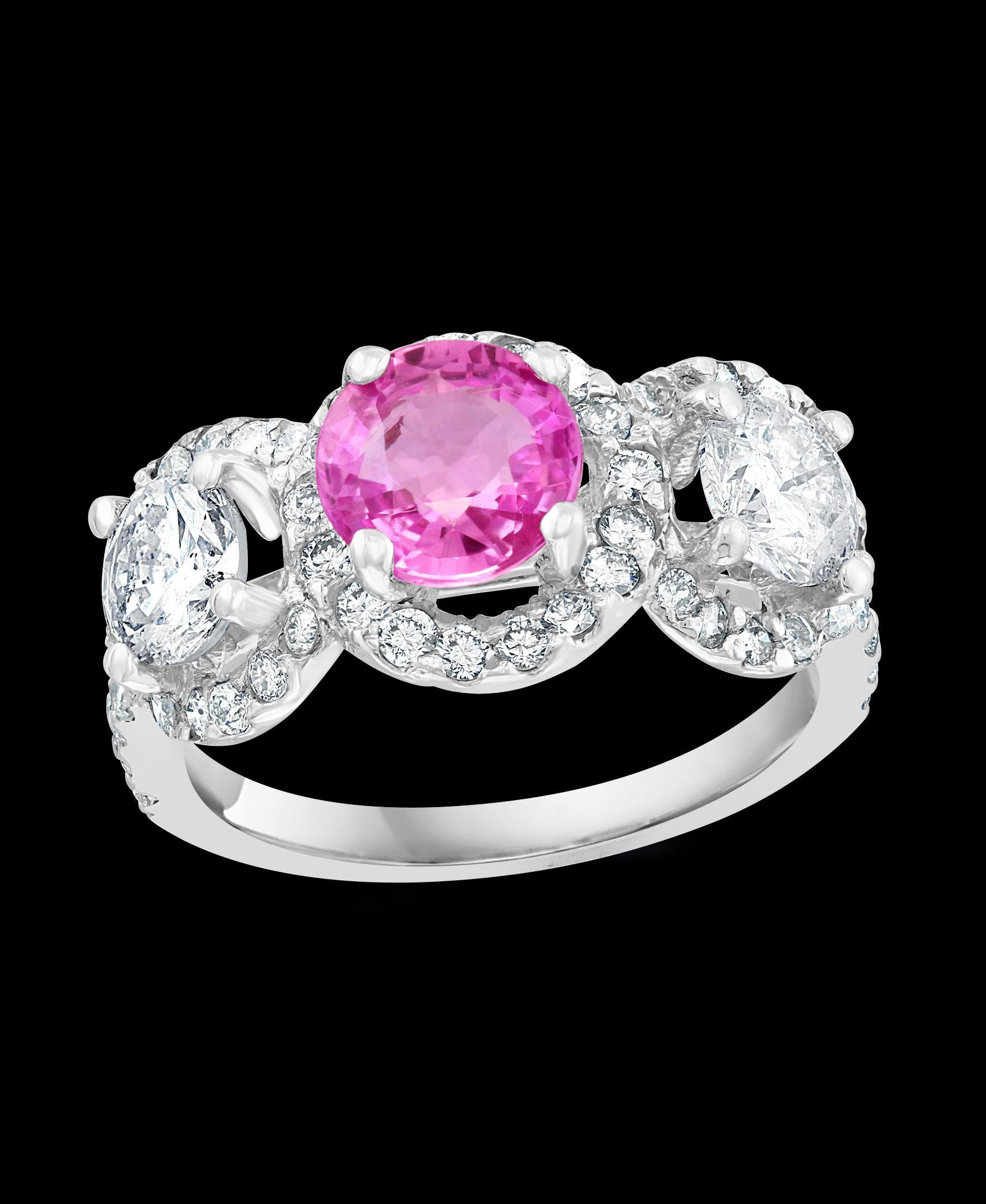 A classic, Ring 
weight of 1 Ct natural Pink sapphire and 1.5 ct  Round  Diamond 18 Karat  White gold   Ring
 All round brilliant cut diamonds, Total diamonds 1.5 ct while there are two solitaire diamonds , Each solitaire diamond is 0.45ct
Natural