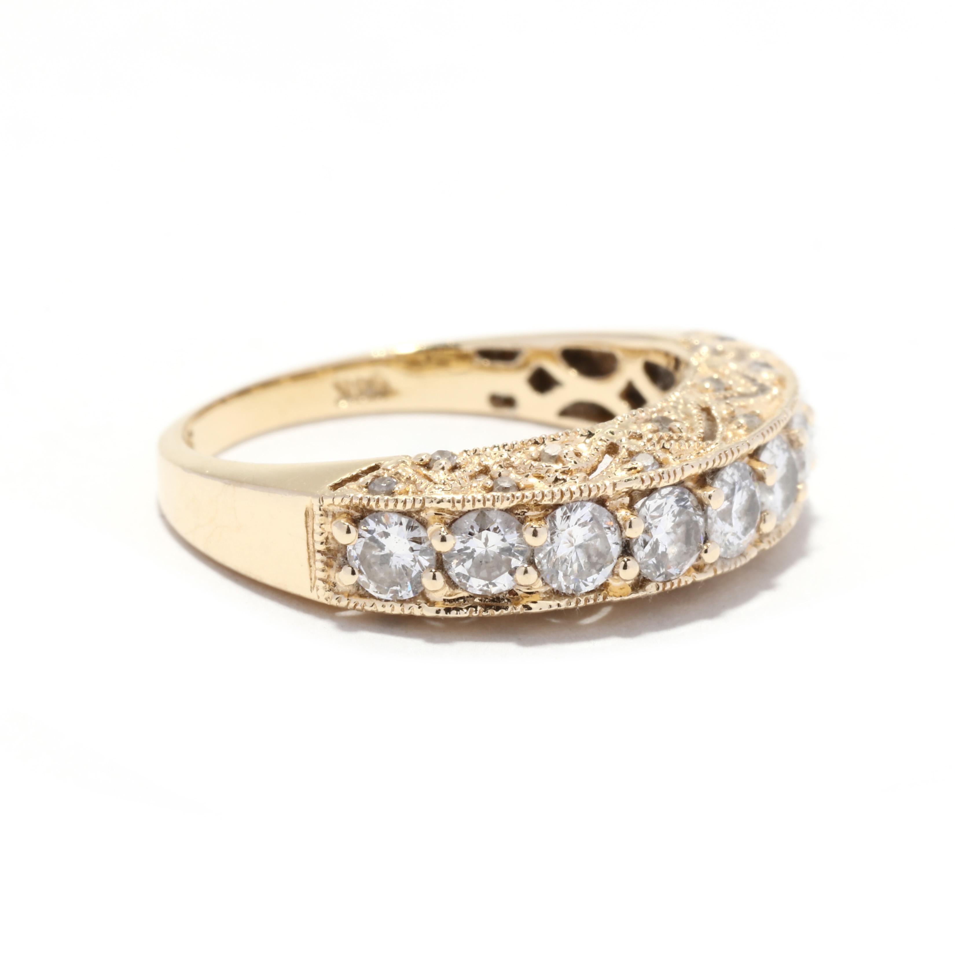 A 14 karat yellow gold nine stone diamond wedding band. This stackable band features a slightly domed band set with nine full cut round diamonds weighing approximately 1 total carat and with a pierced milgrain detailed profile set with single cut