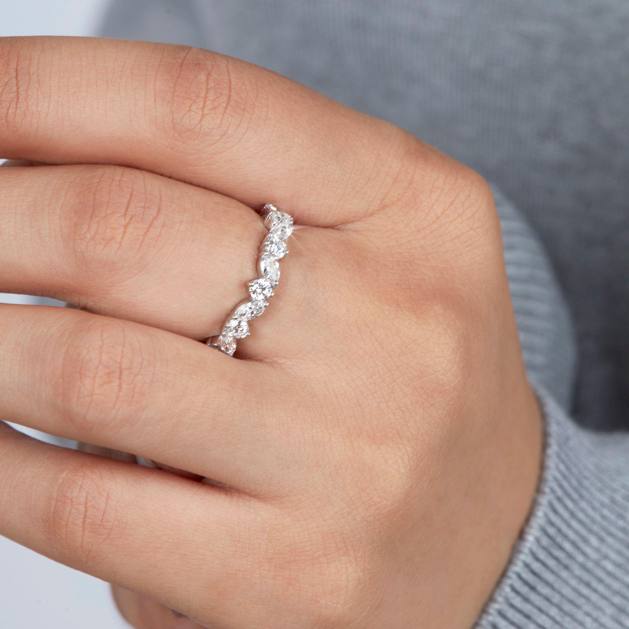 This 1.00 CT Marquise Round Natural Diamond Ring is an epitome of luxurious charm and timeless design. The ring features a unique combination of marquise and round cut diamonds, meticulously arranged to create a multi-stone half-infinity band that