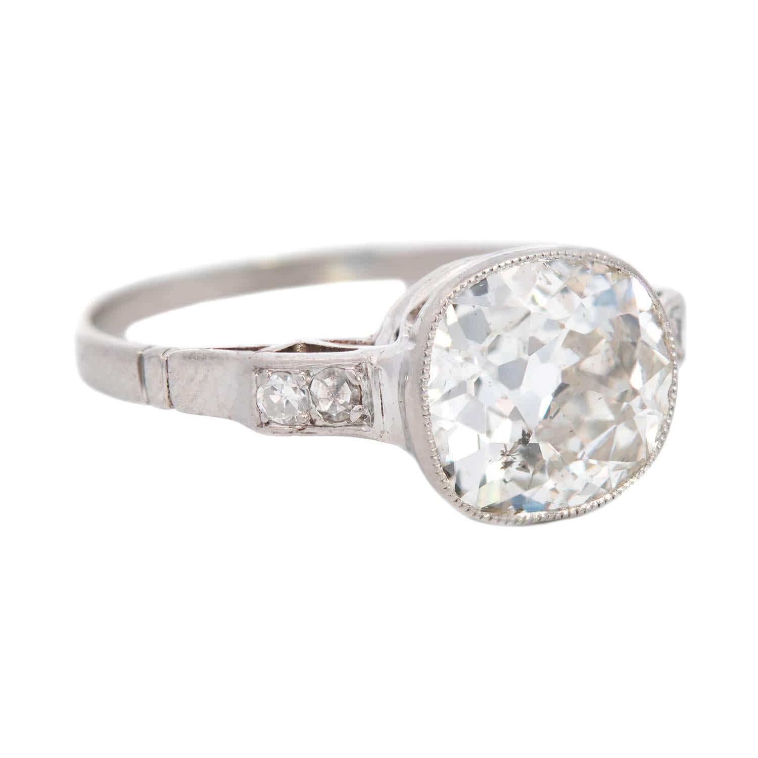 A stunning diamond engagement ring from the late Art Deco (ca1930) era! Crafted in platinum, this gorgeous piece features a stunning old Cushion Cut diamond at its center that weighs approximately 2.06ct and displays I/J color and SI2 clarity,
