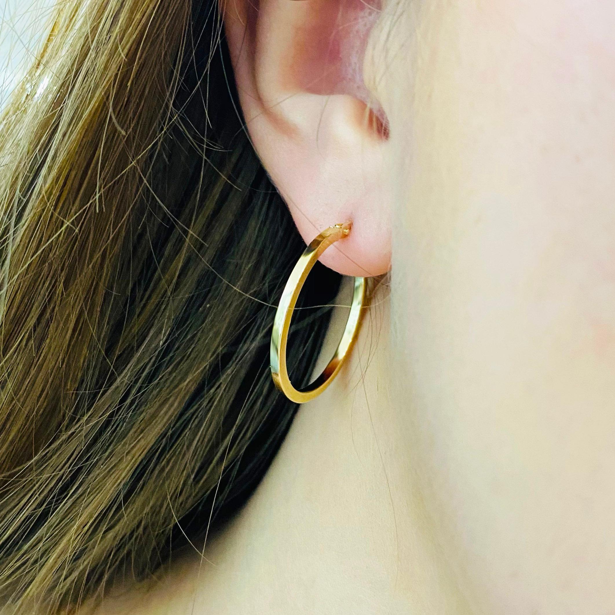 These stunning polished 14k yellow gold hoops provide a look that is both trendy and classic. While they were once worn by kings and queens to signify power and social status, hoop earrings are now considered a statement of unity and strength. Hoop
