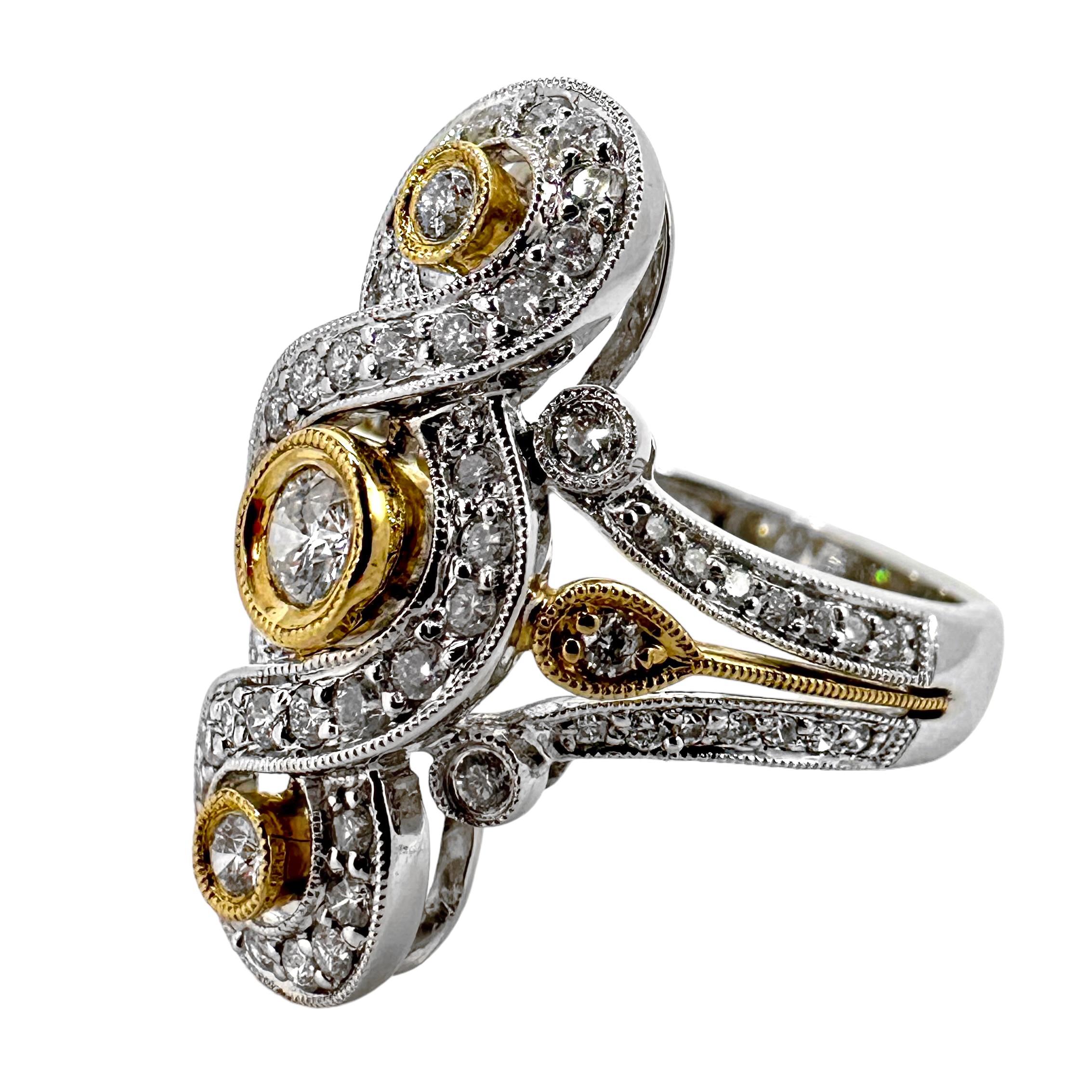 Anello in stile antico dal design allungato in oro 14K con diamanti. Al centro di tre diamanti posizionati da nord a sud in castoni d'oro giallo, c'è un motivo intrecciato in oro bianco con diamanti incastonati. Le spalle dell'anello hanno un design