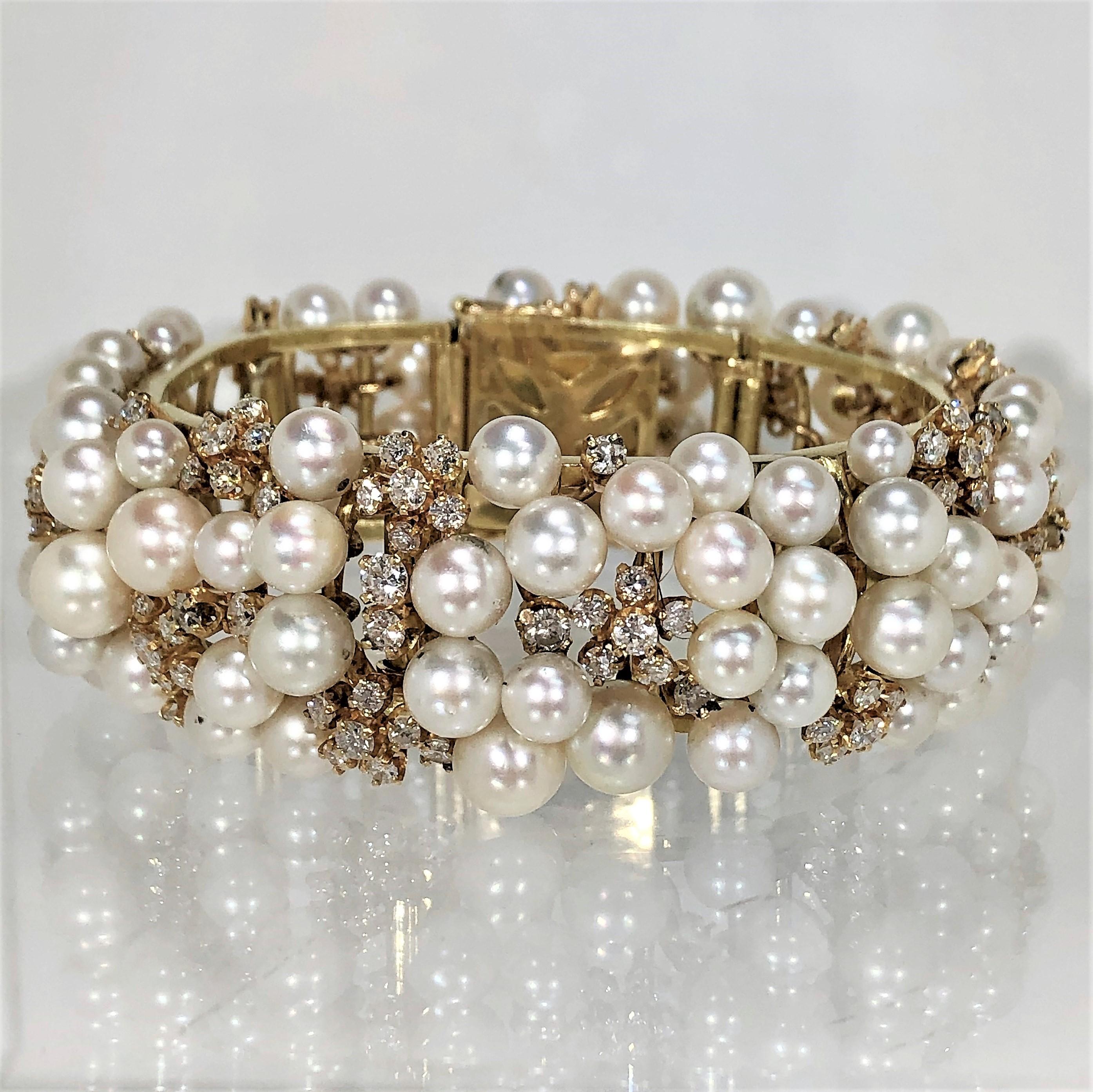 Beautiful 18K Yellow Gold cultured pearl and diamond cocktail
bracelet by designer K. Lambert. The assorted pearls graduate
in size from 5mm to 8mm. The round brilliant cut diamonds weigh
an approximate total of 7.75CT of overall H Color and SI1
